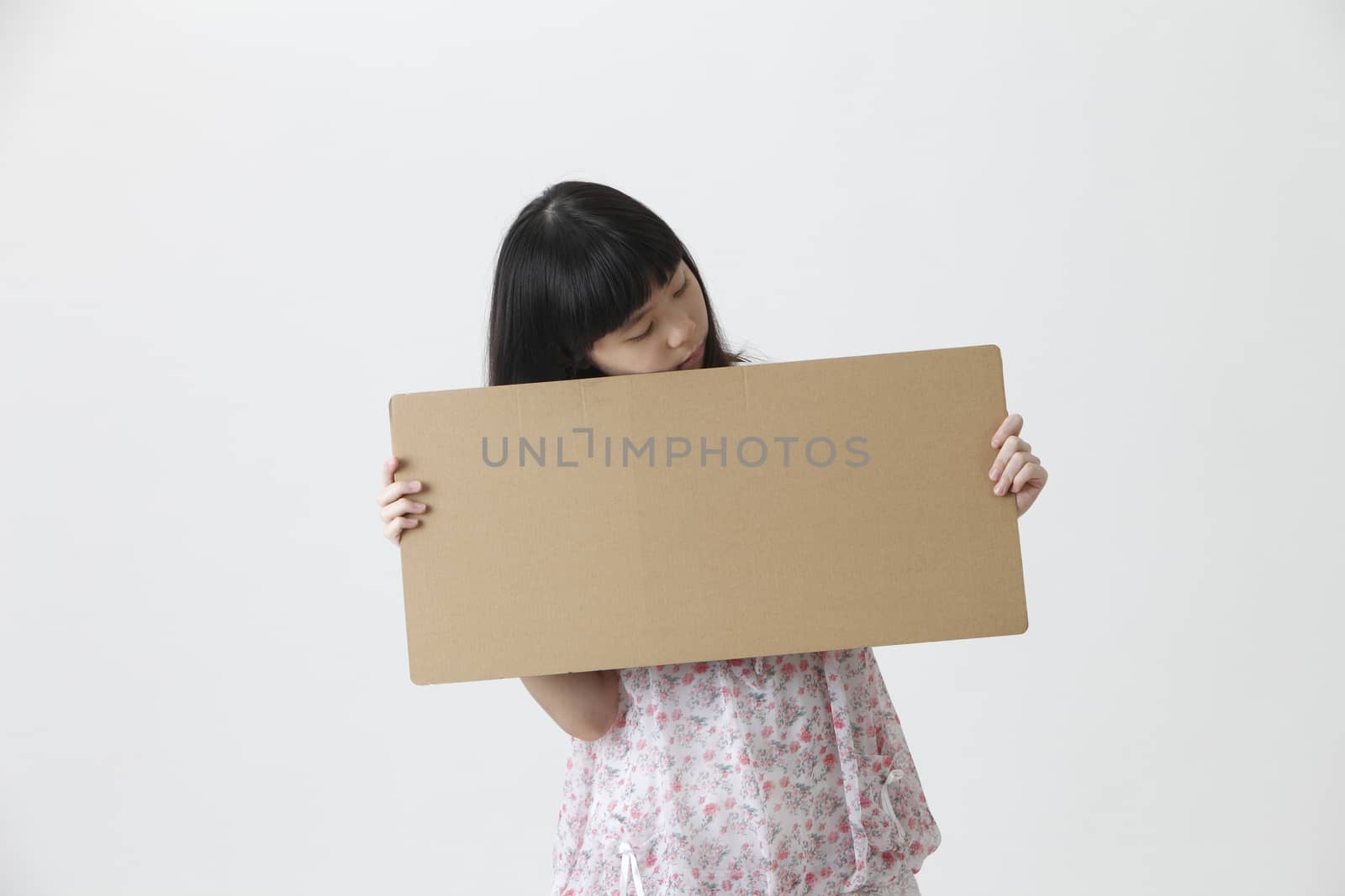 chinese girl holding and looking at brown message board