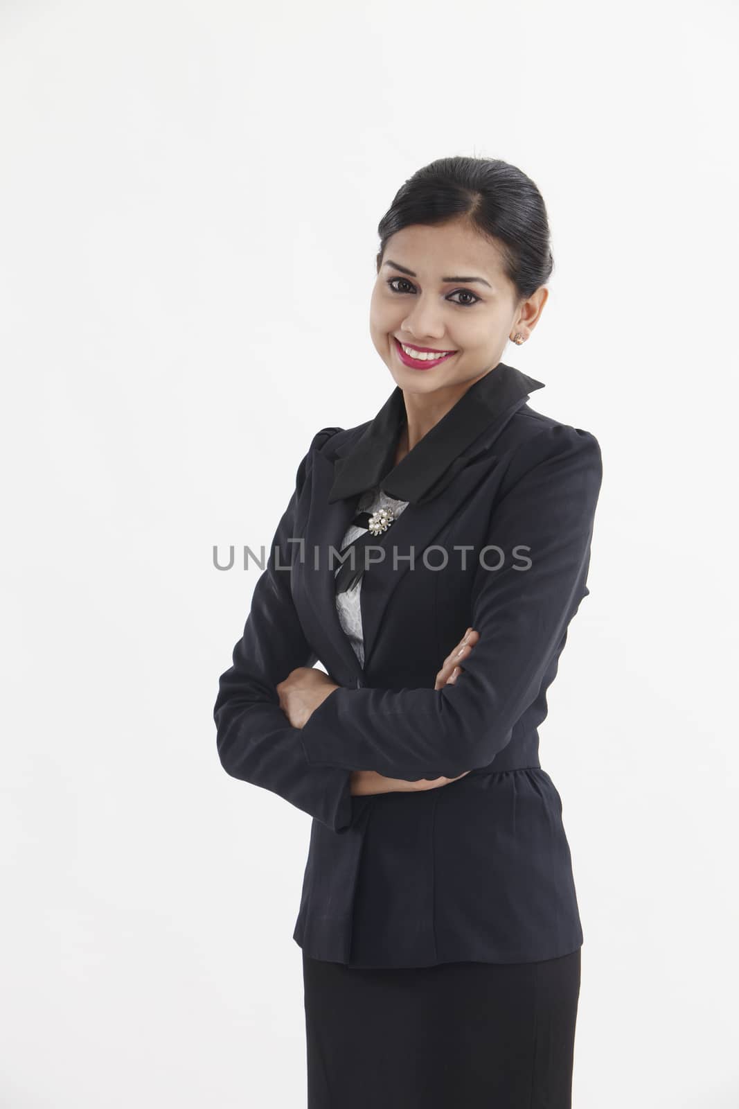Portrait of a well-dressed young business woman with cross-armed

