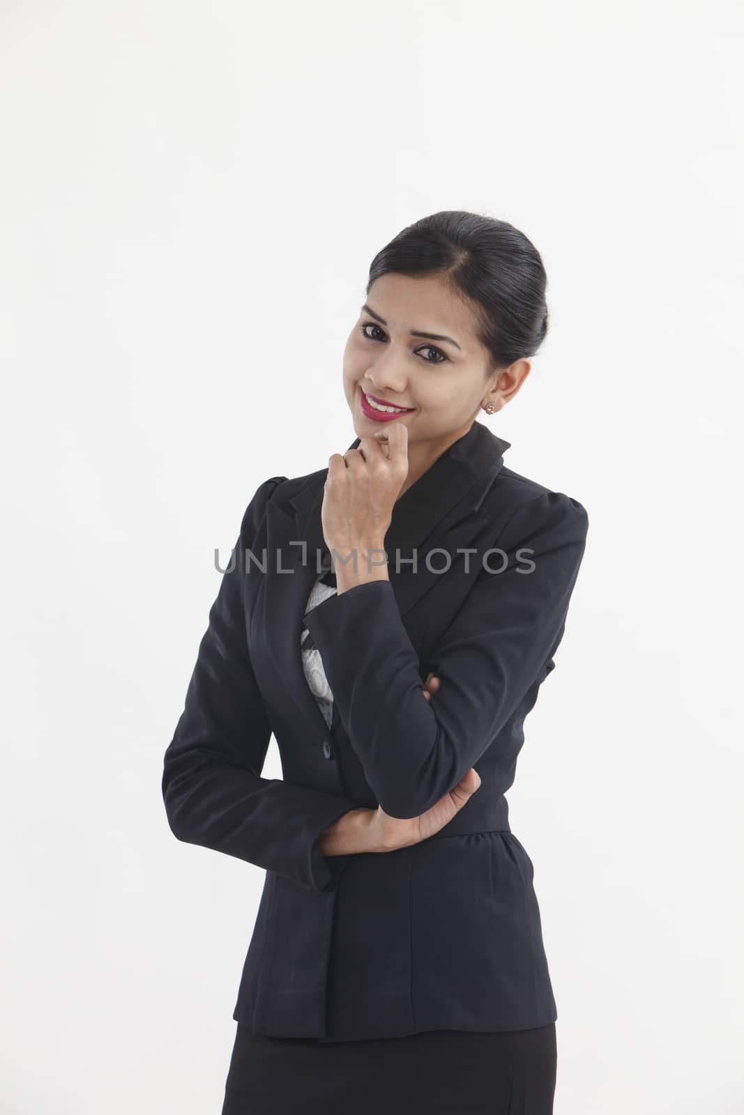 Close up portrait of a smiling business woman thinking on isolated white background