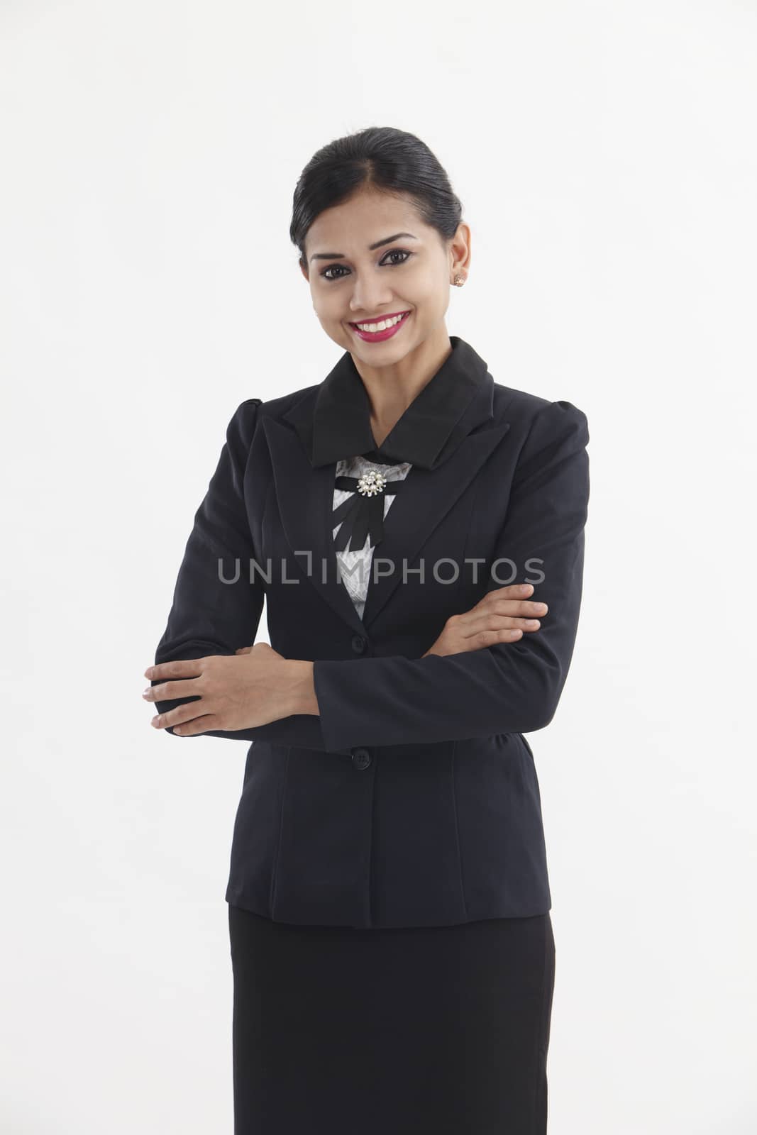 Portrait of a well-dressed young business woman with cross-armed

