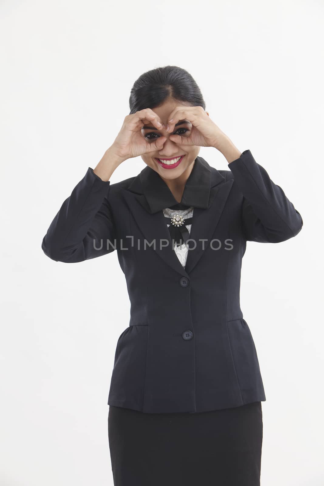 young woman looking through imaginary binocular