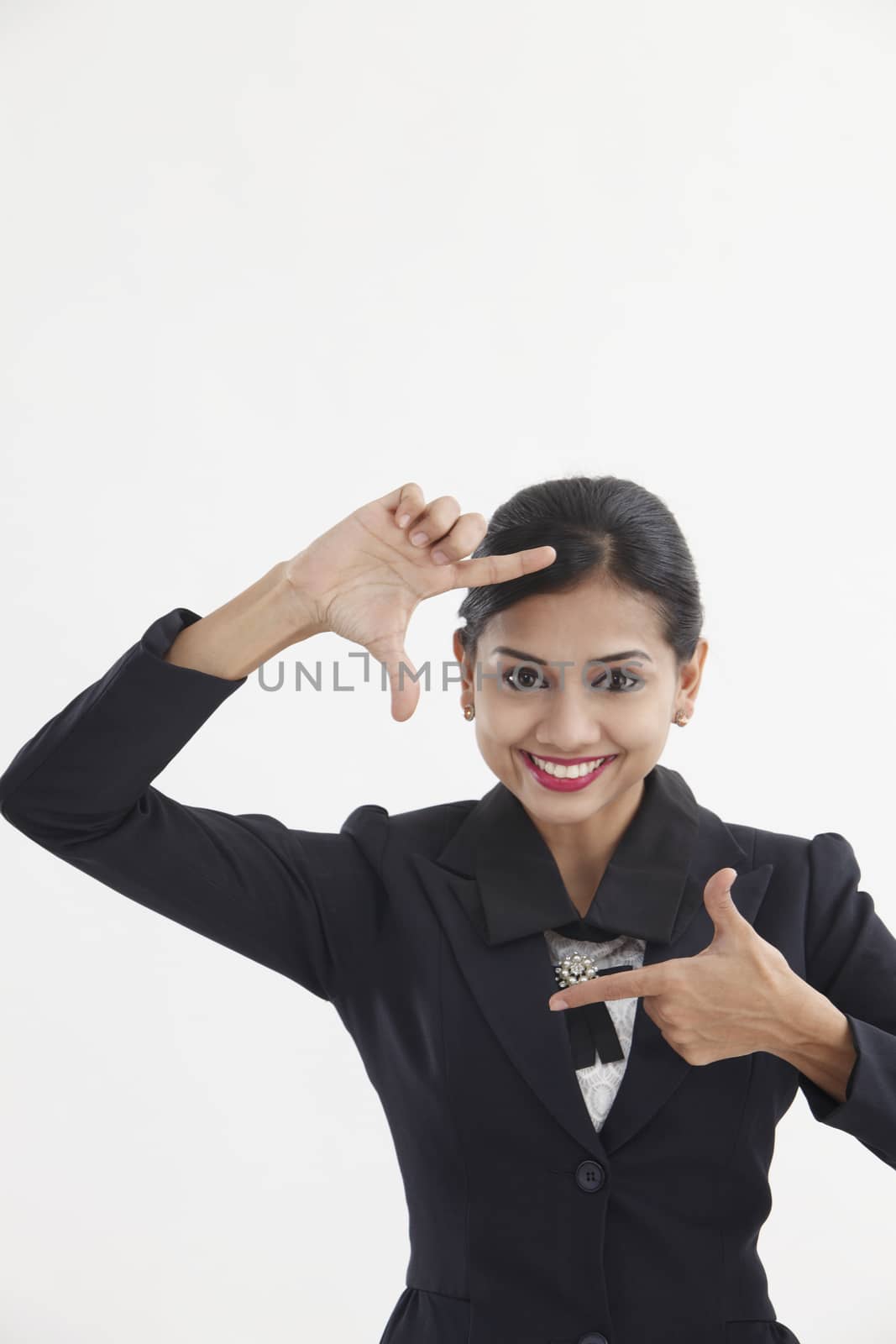 Business woman making a hand frame, isolated on white