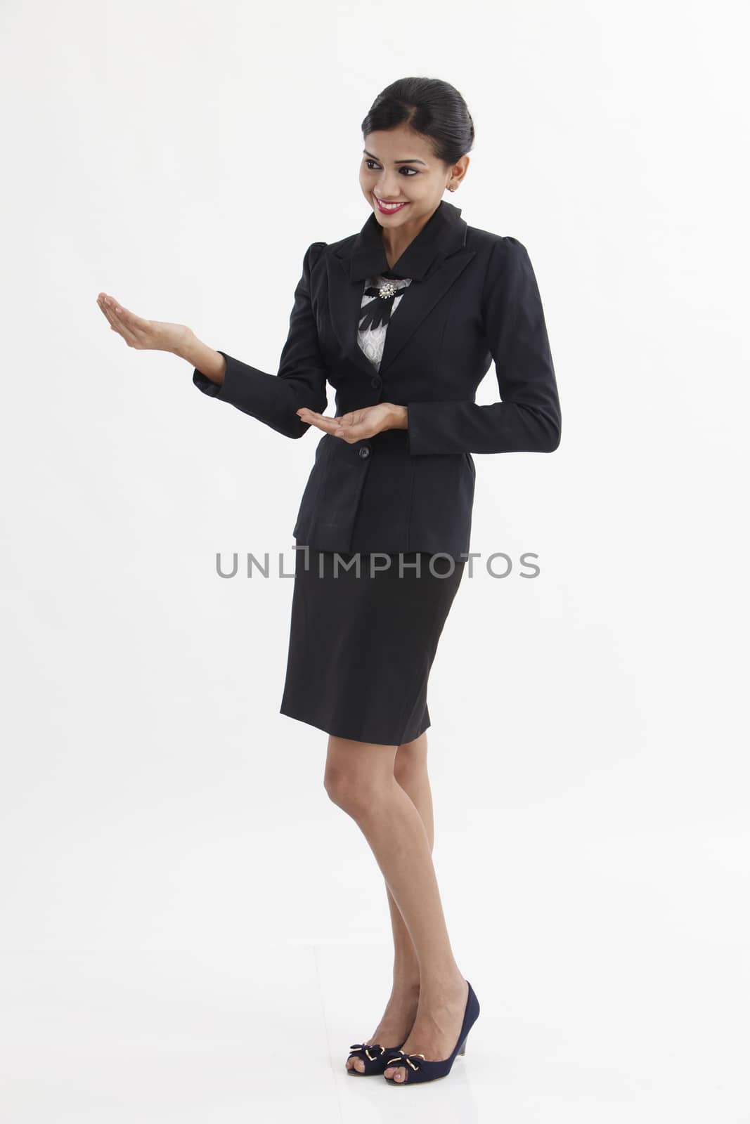 Business woman pointing at copy space, isolated on white