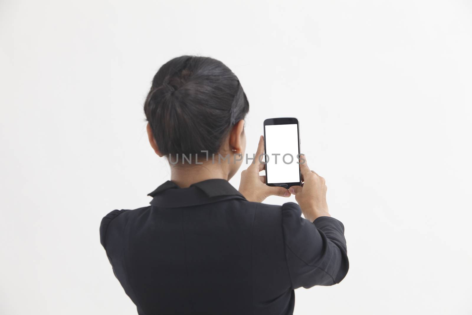 Back view of business woman self portrait with smart phone
