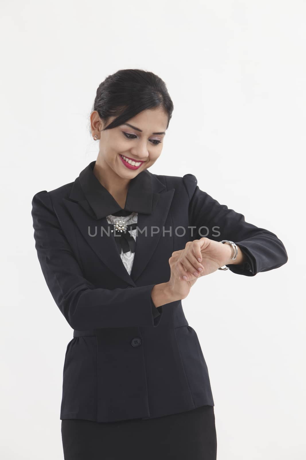 businesswoman looking at her watch checking time