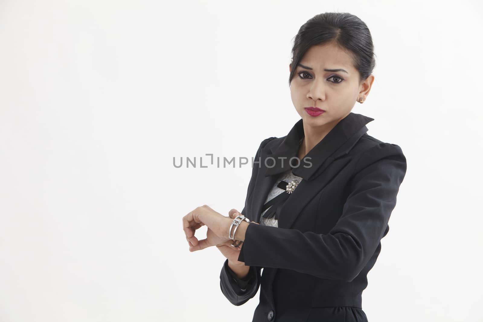 businesswoman looking at her watch checking time