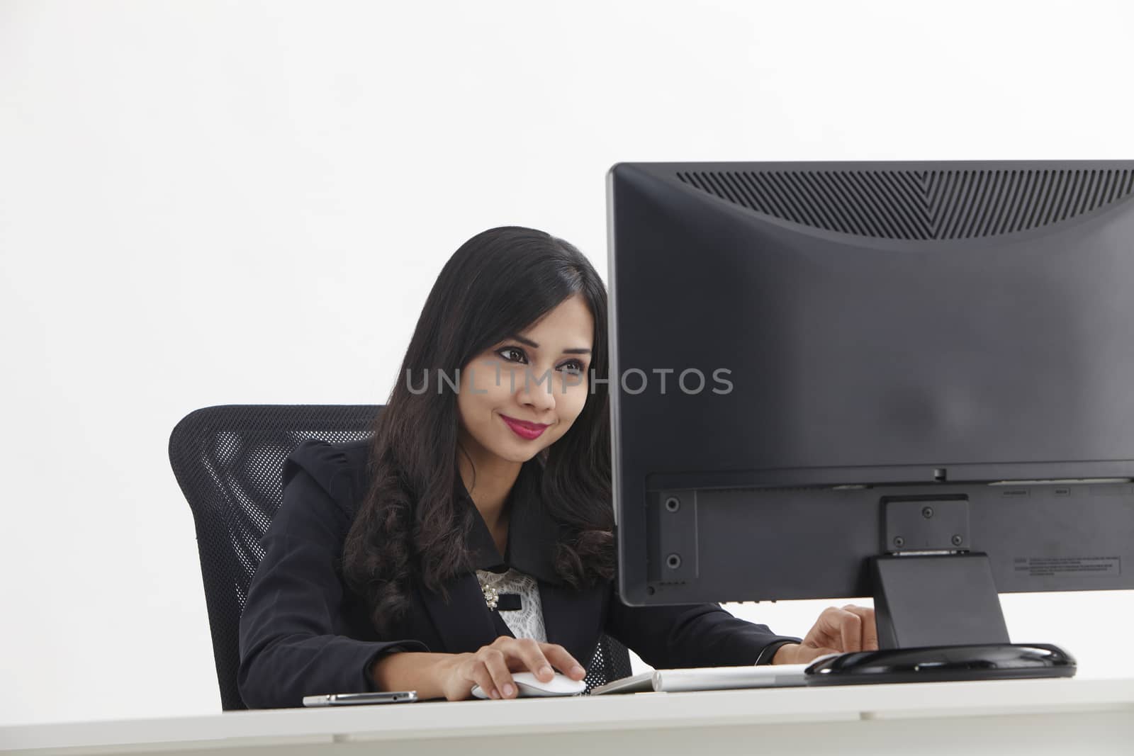 business woman sitting in front monitor working