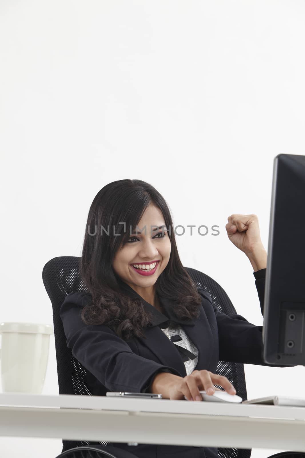 business woman sitting in front monitor cheering