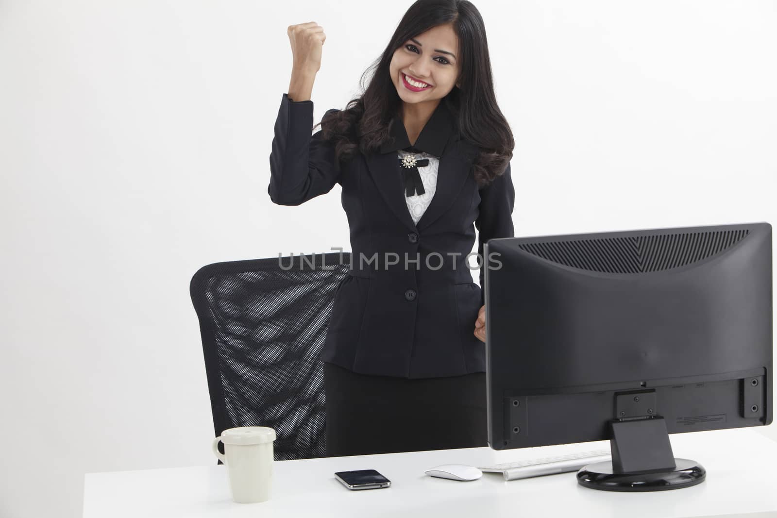 business woman standing in front monitor cheering