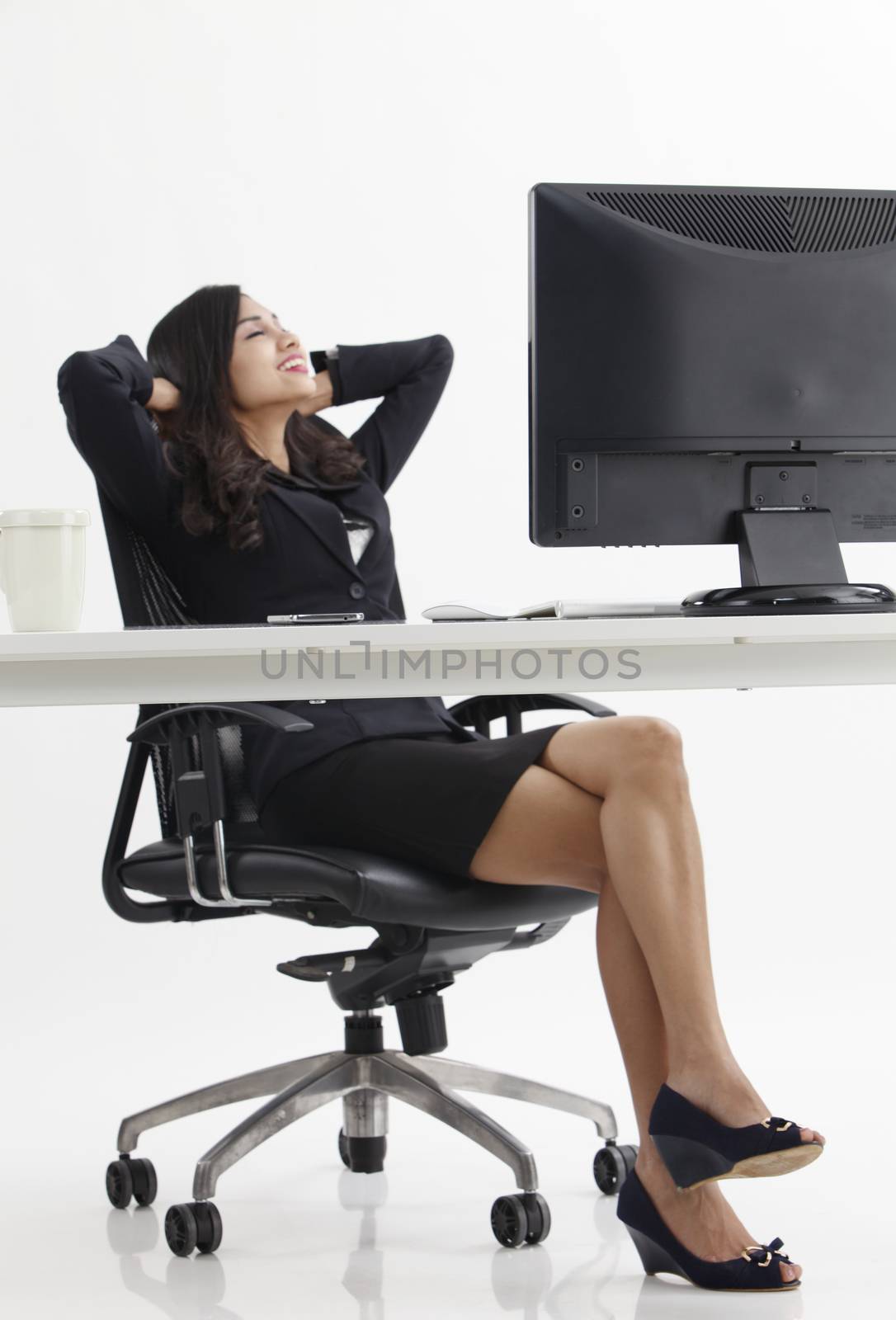 businesswoman relaxing as background focus on the foreground monitor