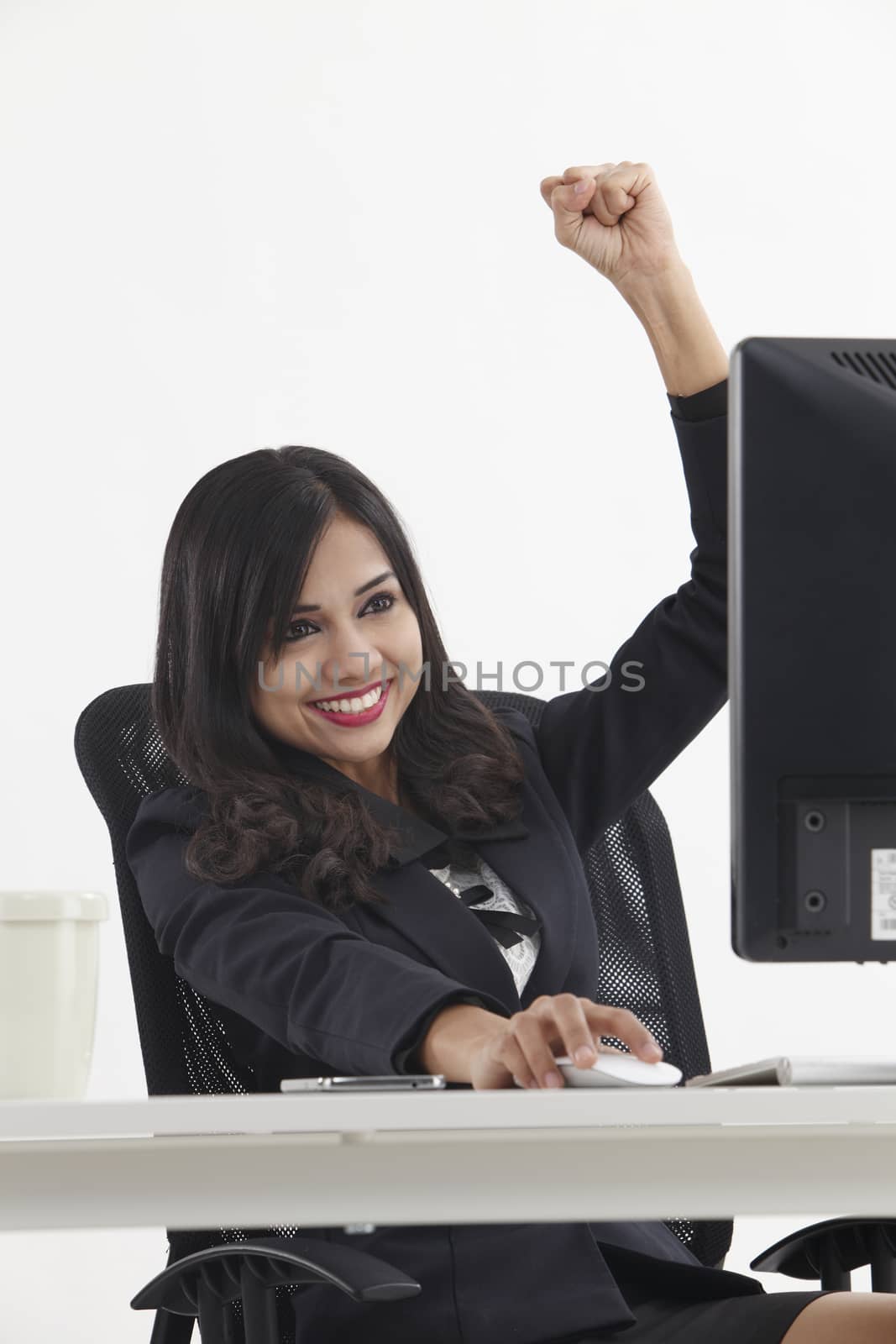 business woman sitting in front monitor cheering