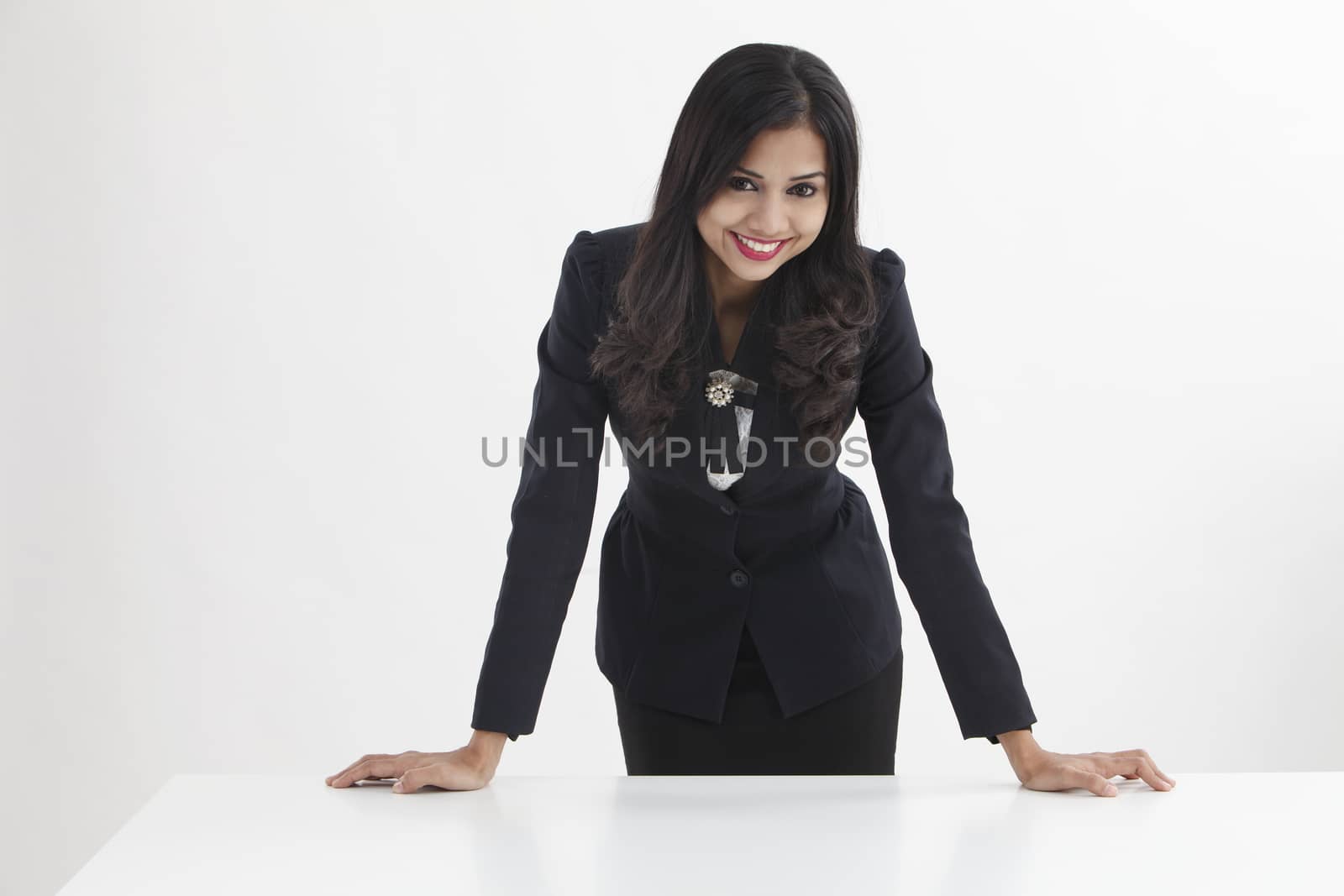 businesswoman standing behind of the desk confident