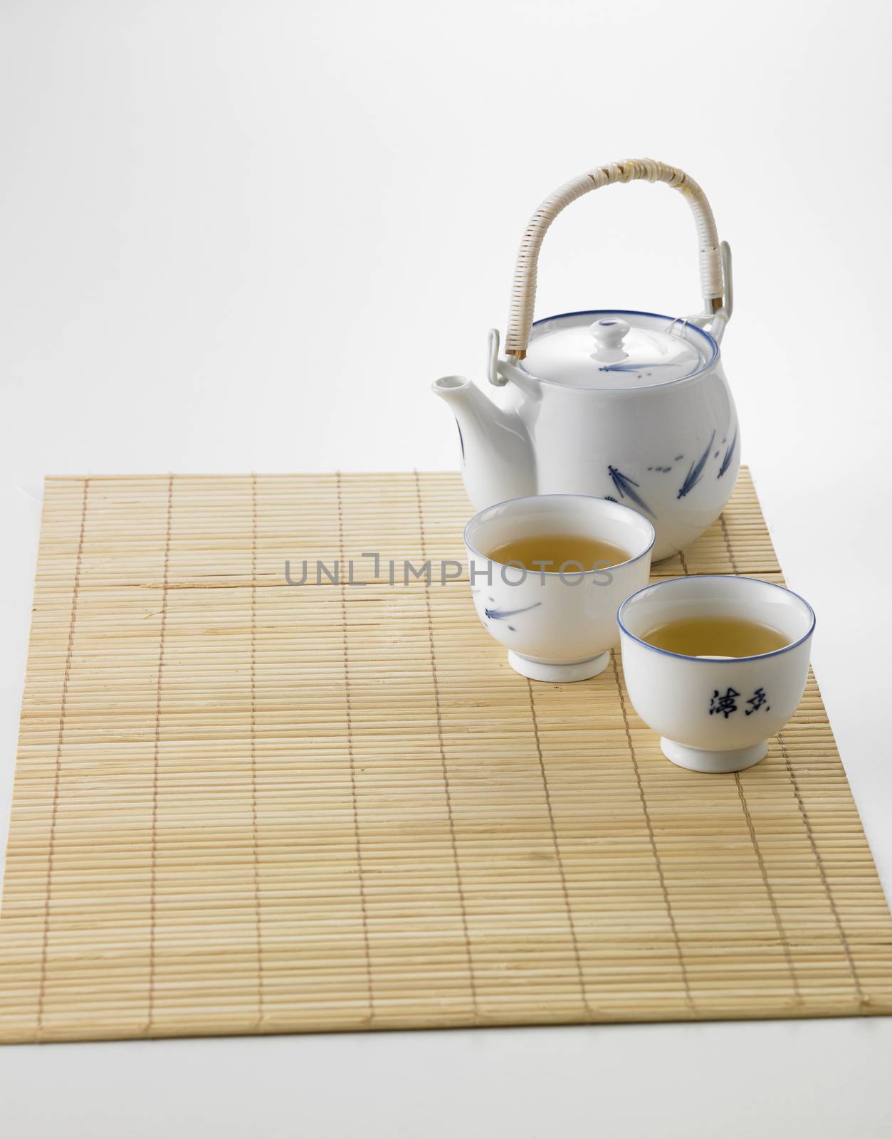 Japanese white tea pot on the bamboo mat