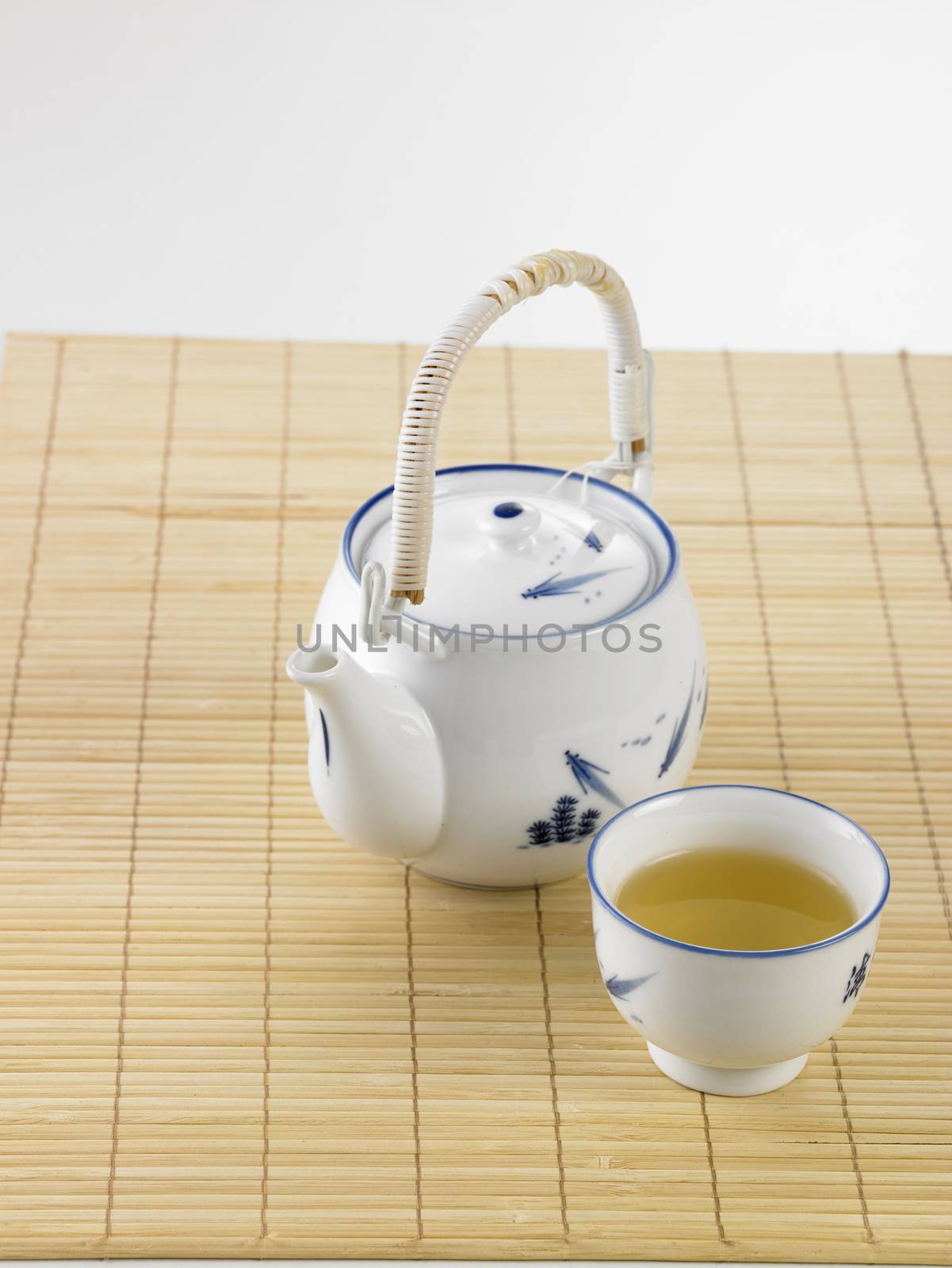 Japanese white tea pot on the bamboo mat