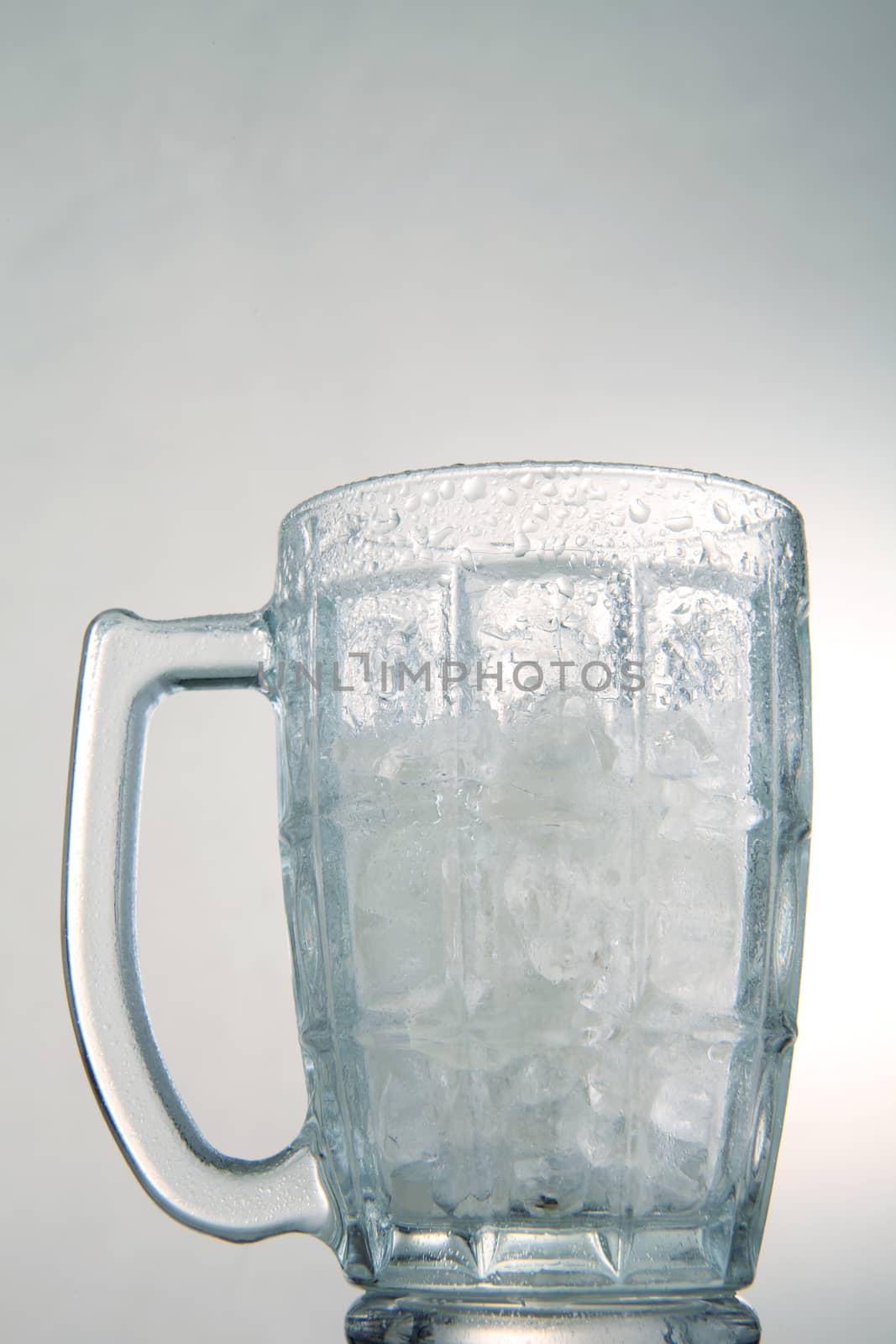 photo of empty glass with ice cubes on white background