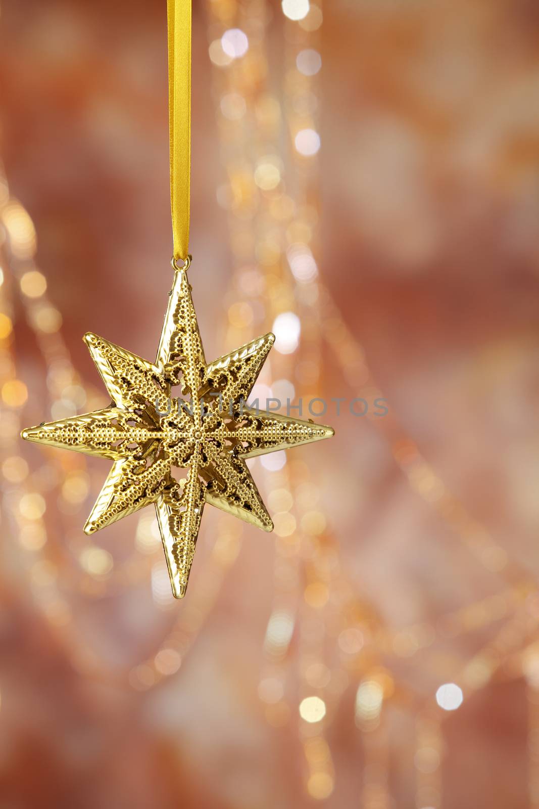 Christmas golden star on a on the warm background