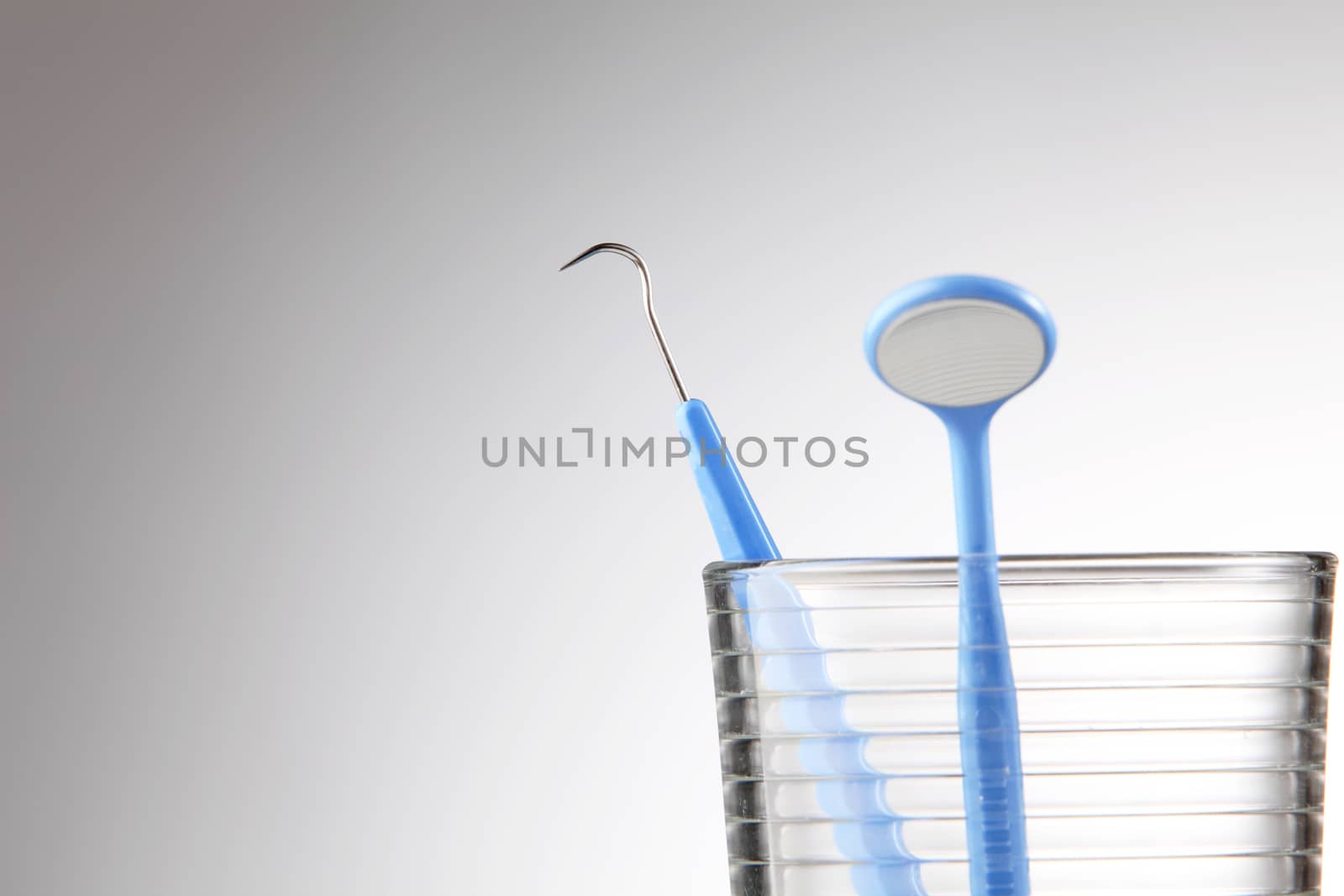 Dentist tools in glass table close up