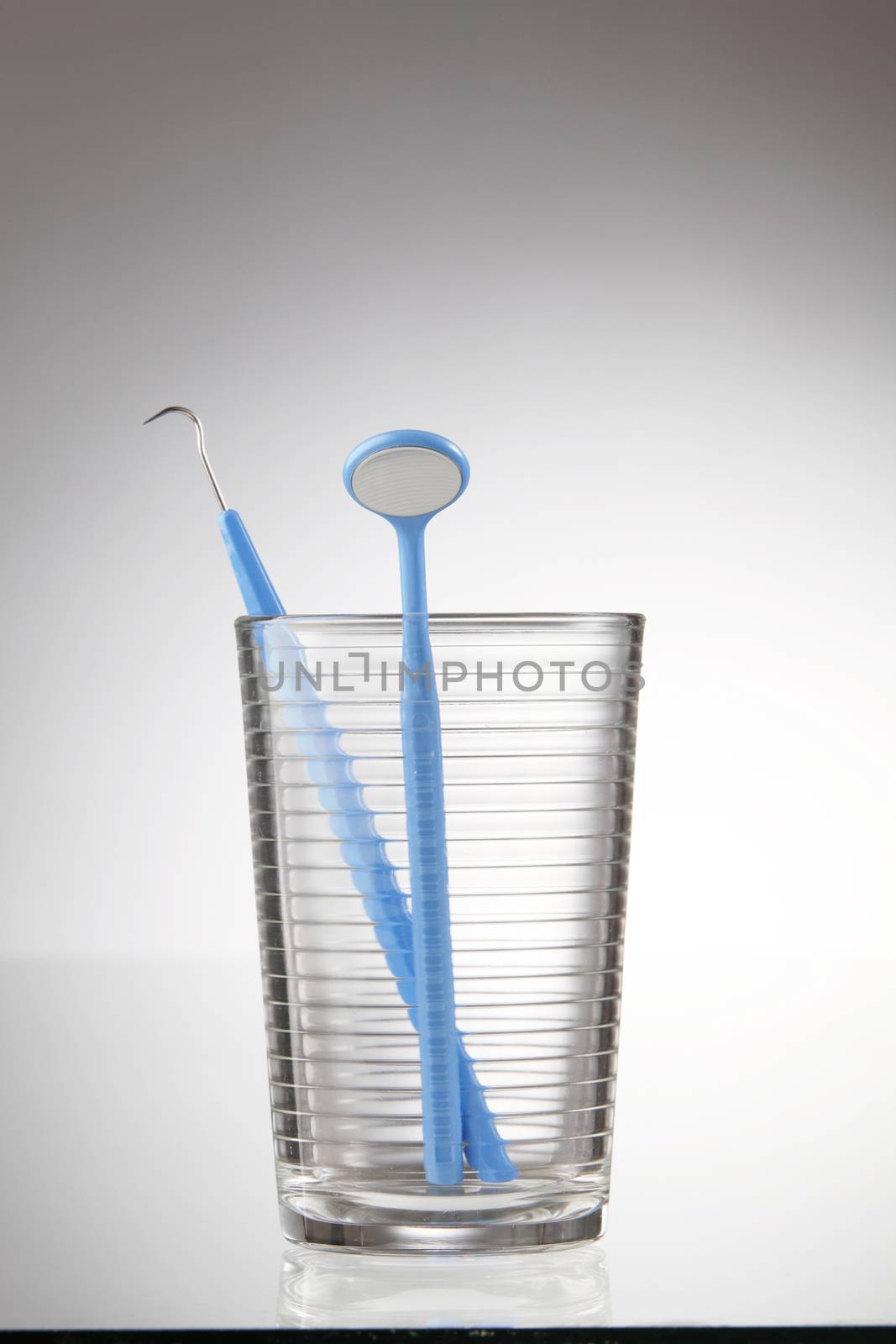 Dentist tools in glass table close up