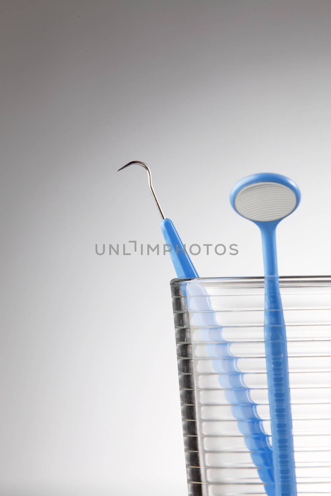 Dentist tools in glass table close up