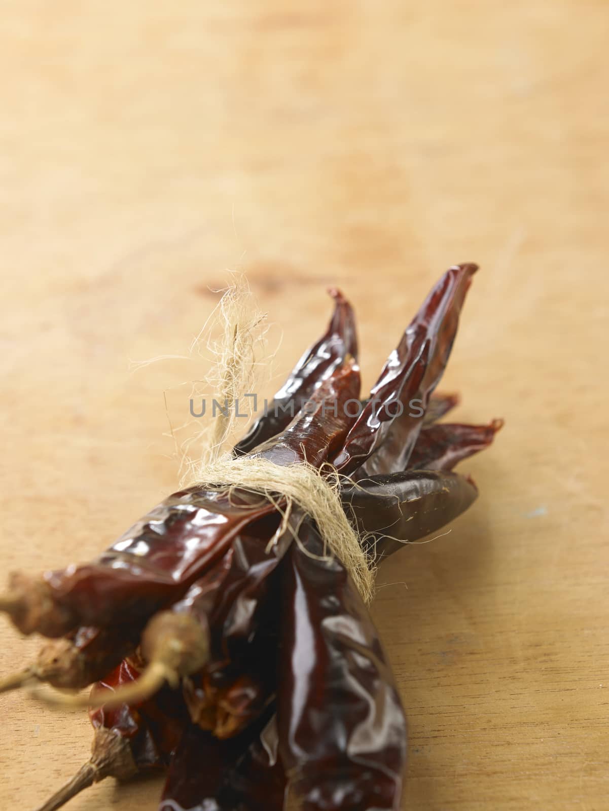 Bunch of dried chili on wooden table top