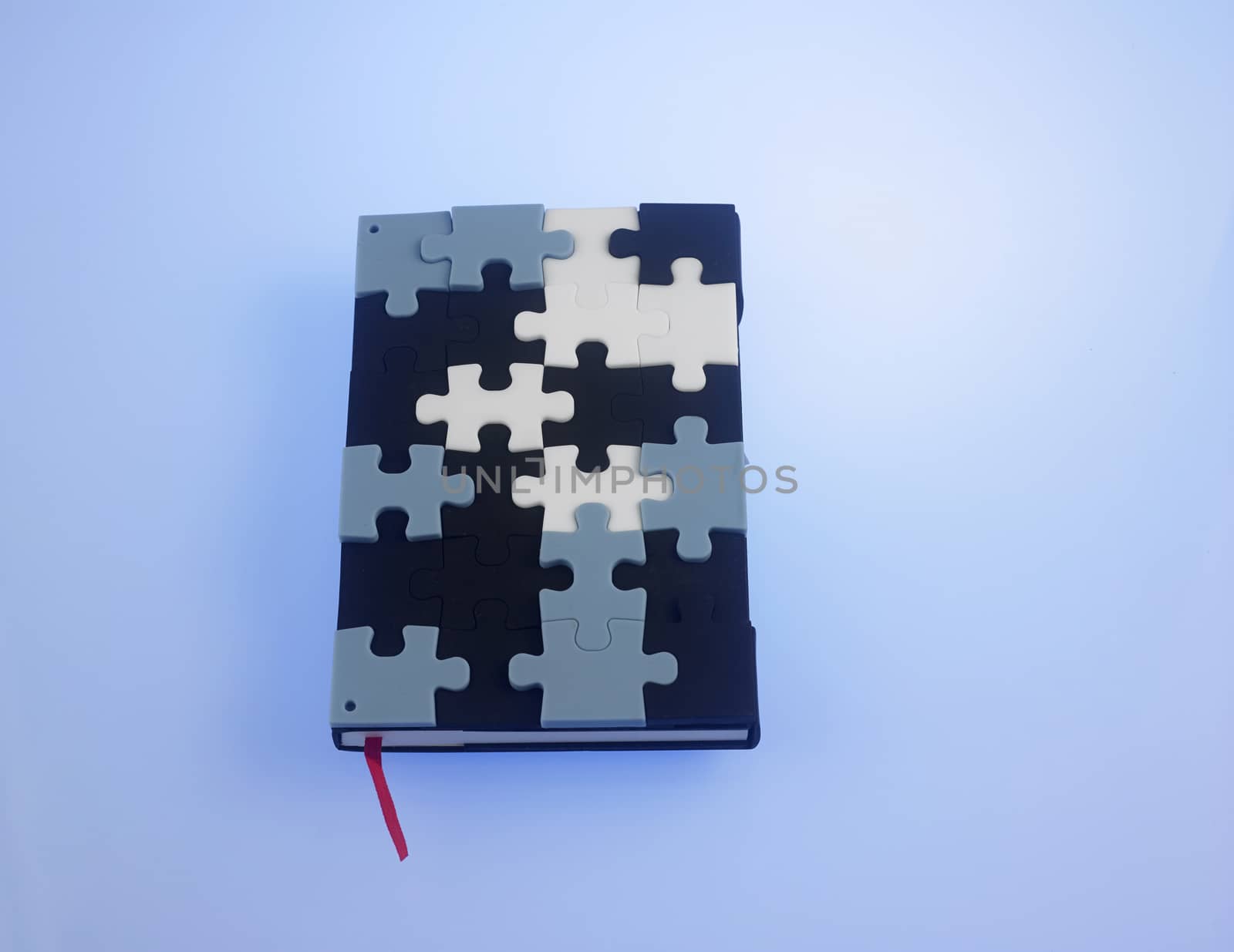 jigsaw puzzle note book on the blue background