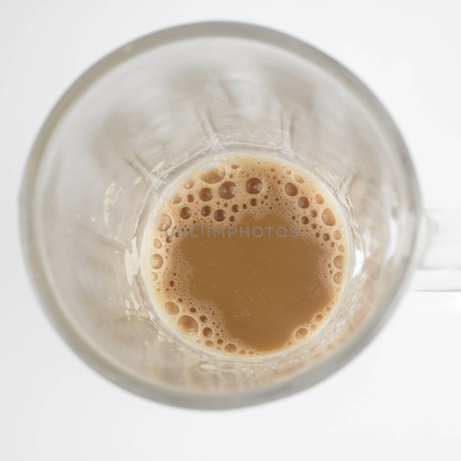 Top view of lnearly empth glass with little Tea with milk or Teh Tarik in Malaysia