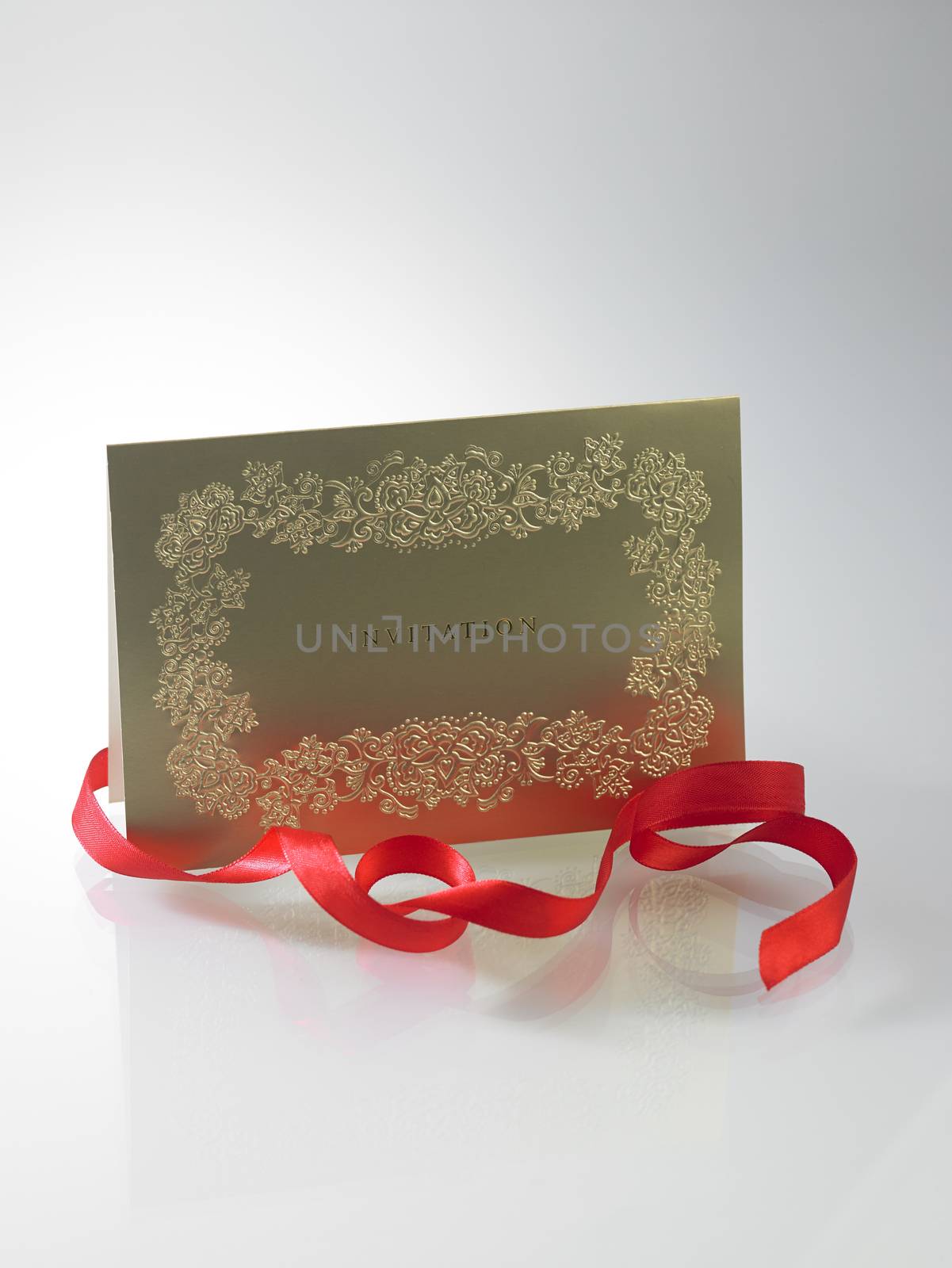 golden invitation card with ribbon