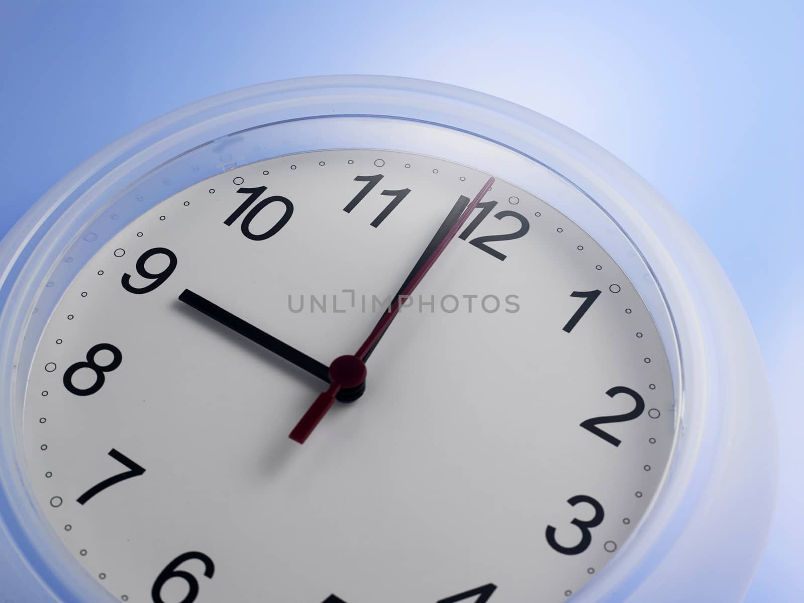 Close up of an analog clock at 9 o'clock


