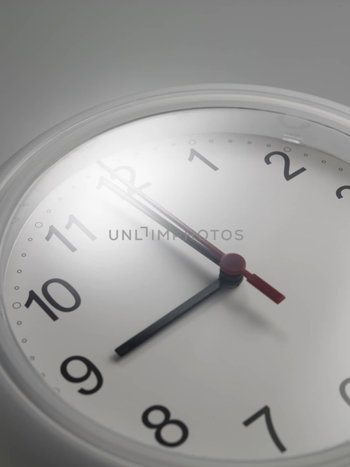 Close up of an analog clock at 9 o'clock

