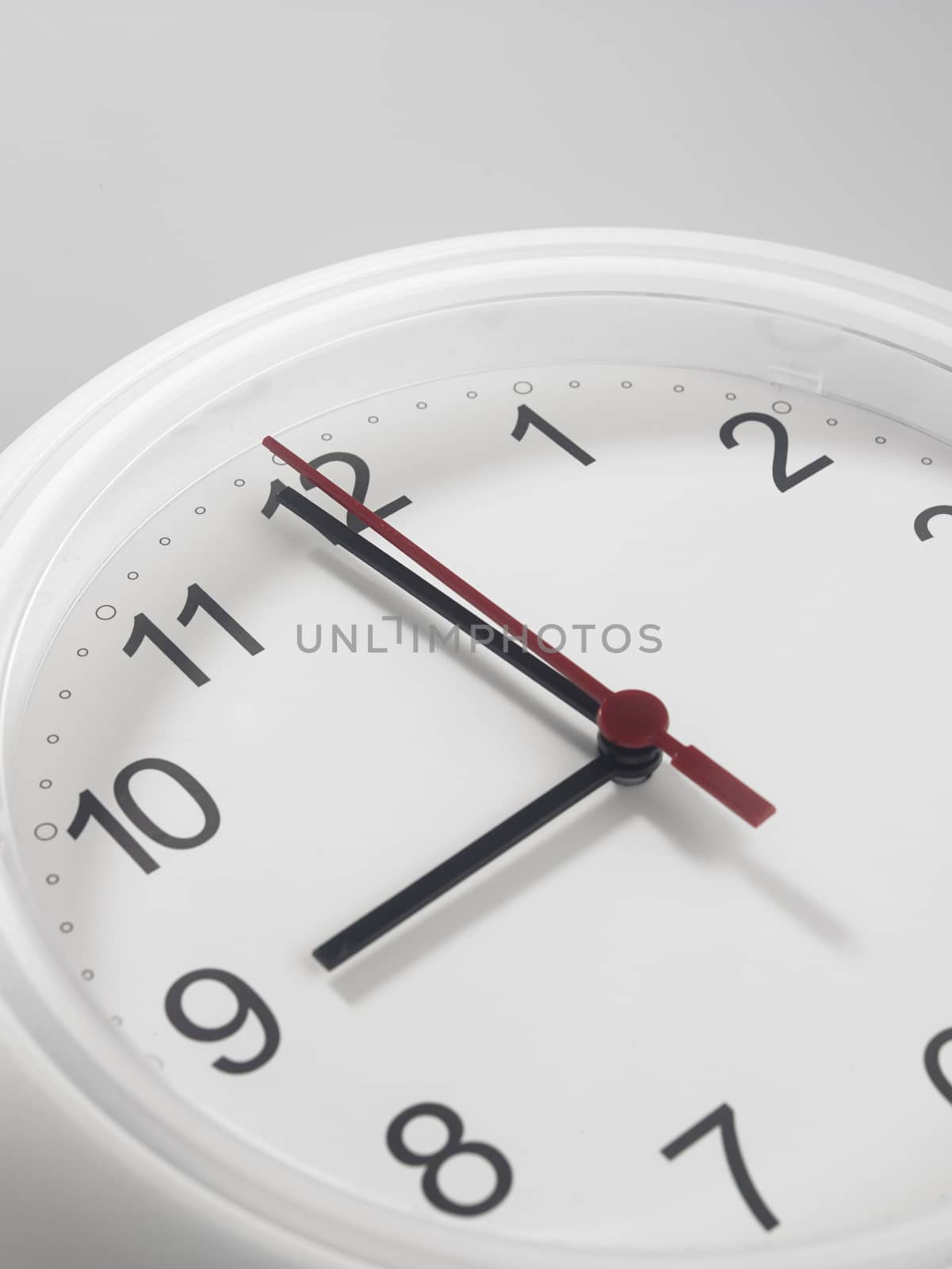 Close up of an analog clock at 9 o'clock

