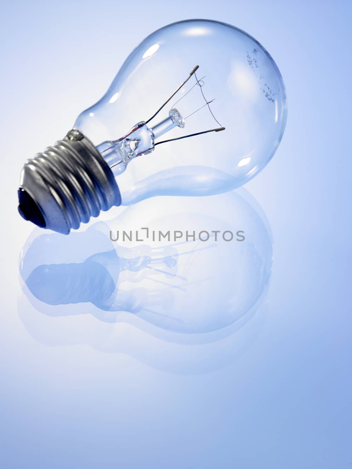 light bulb on the blue background with reflction