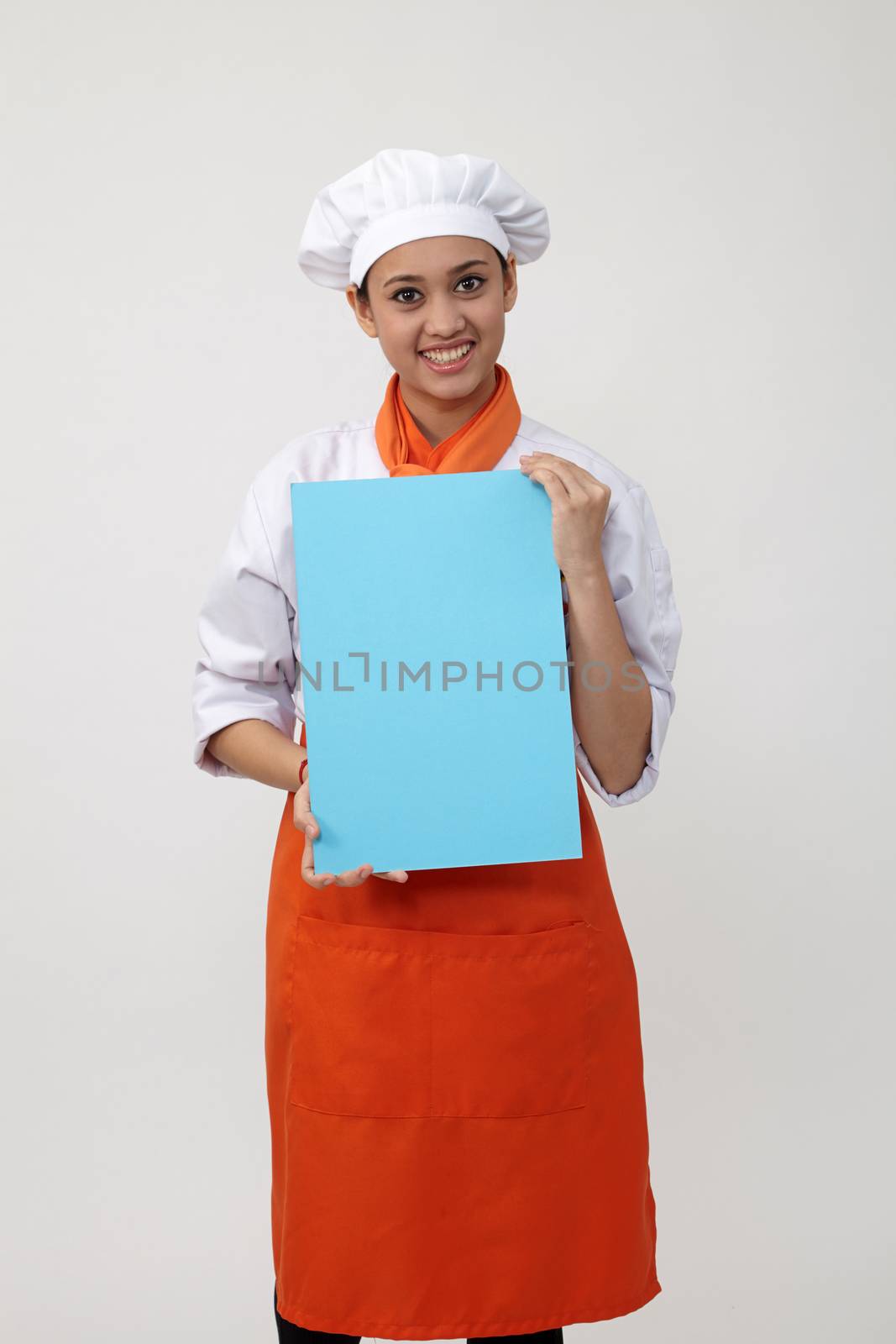 Indian woman with chef uniform holding a blank card