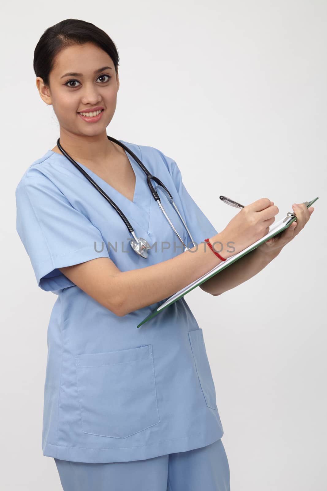nurse writng on the clipboard that she is holding