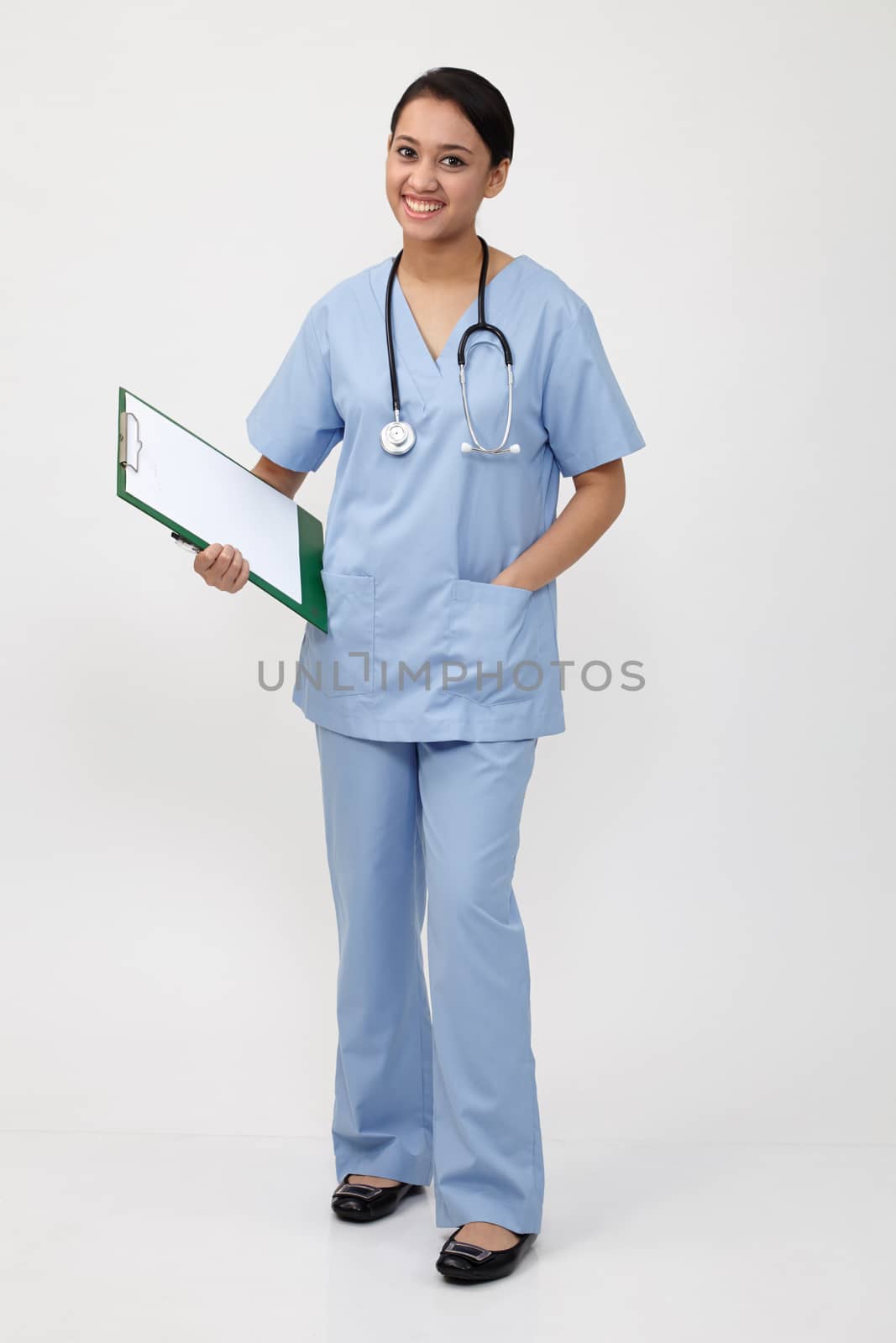 nurse doctor woman smile with stethoscope hold clipboard, wear blue surgery medical suit. Isolated over white background

