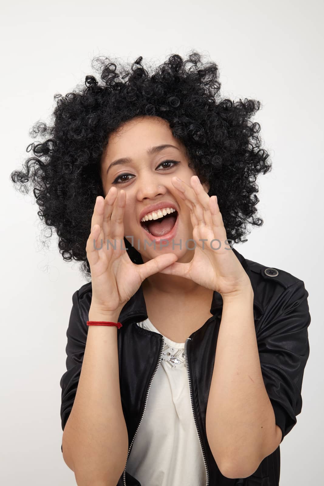 Happy girl with big afro hair shouting