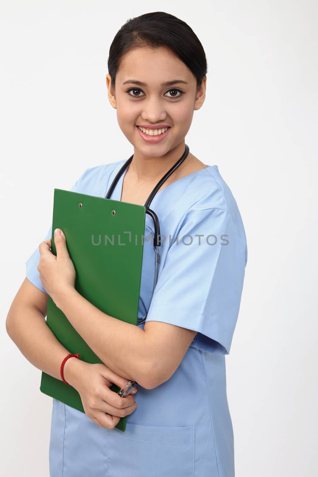 nurse doctor woman smile with stethoscope hold clipboard, wear blue surgery medical suit. Isolated over white background

