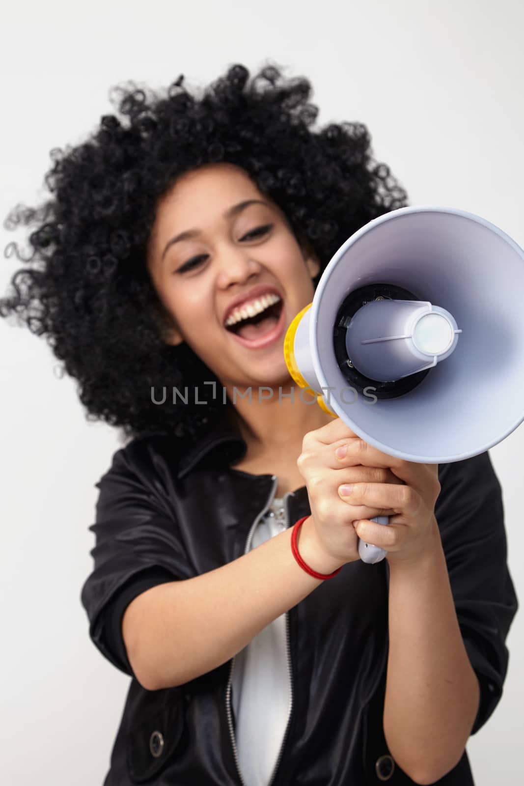 Indian teenage holding a megaphone on the white background