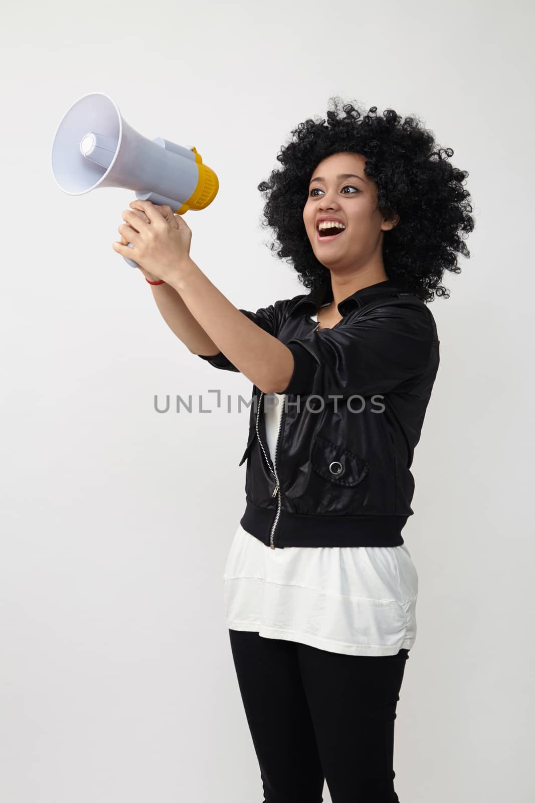 Indian teenage holding a megaphone on the white background