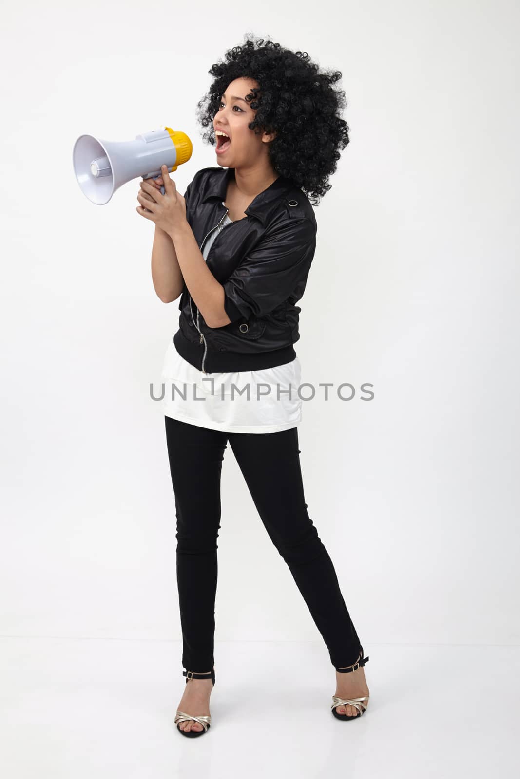 Indian teenage holding a megaphone on the white background