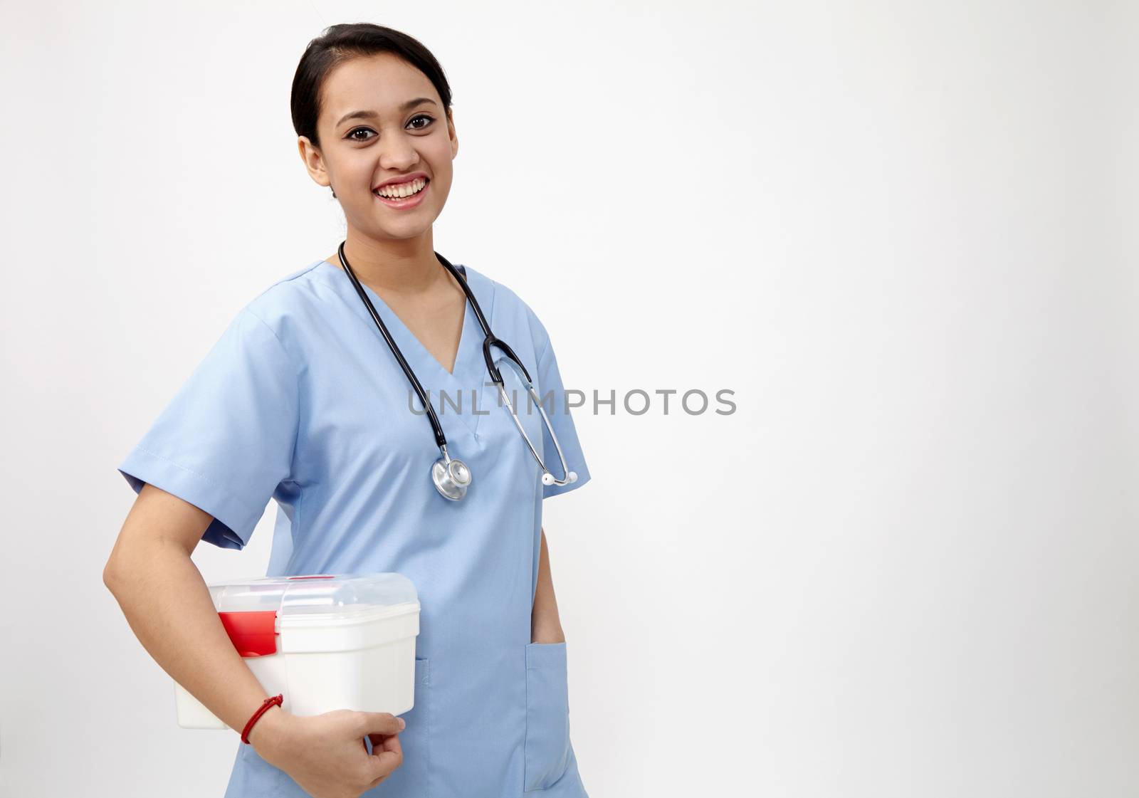 female nurse or doctor carrying a portable first aid kit isolated on white