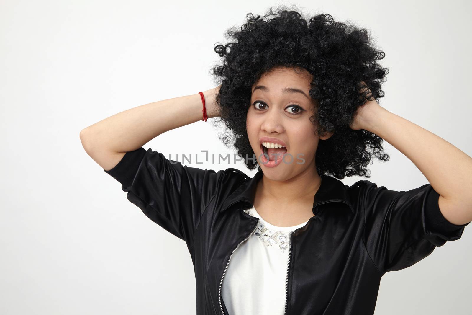 Happy girl with big afro hair with surprise expression