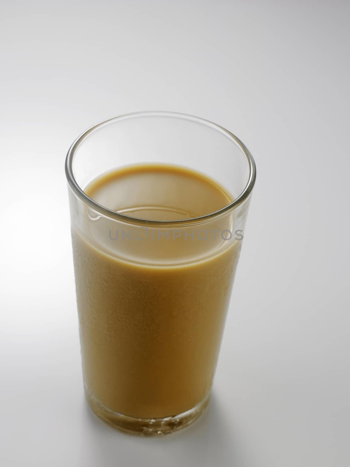 Ice coffee in a glass over gray background