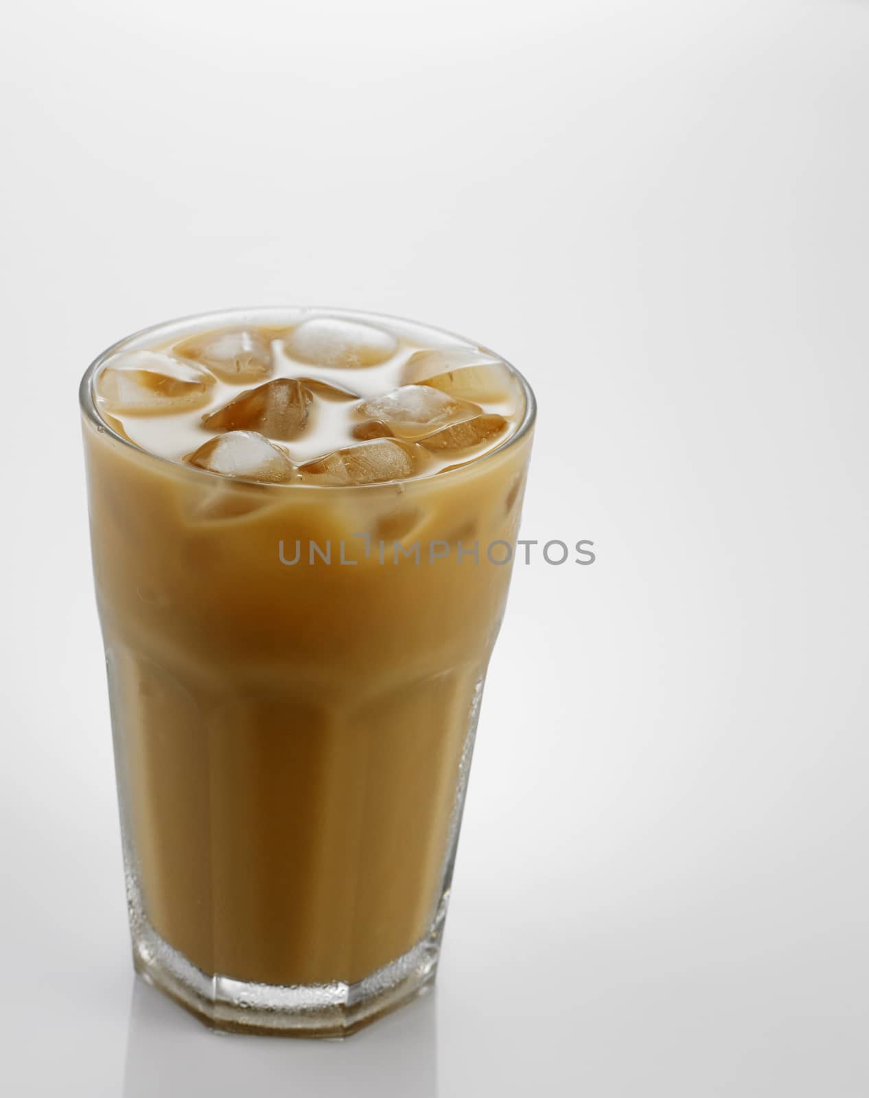 Ice coffee in a glass over gray background