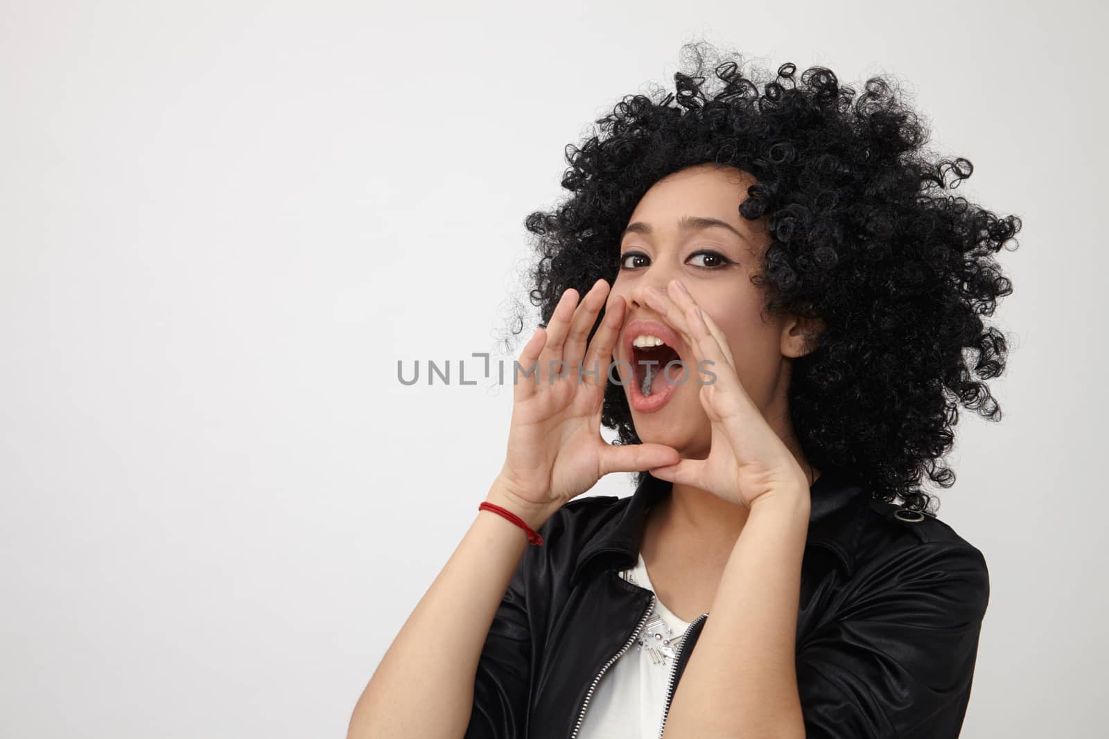 Happy girl with big afro hair shouting