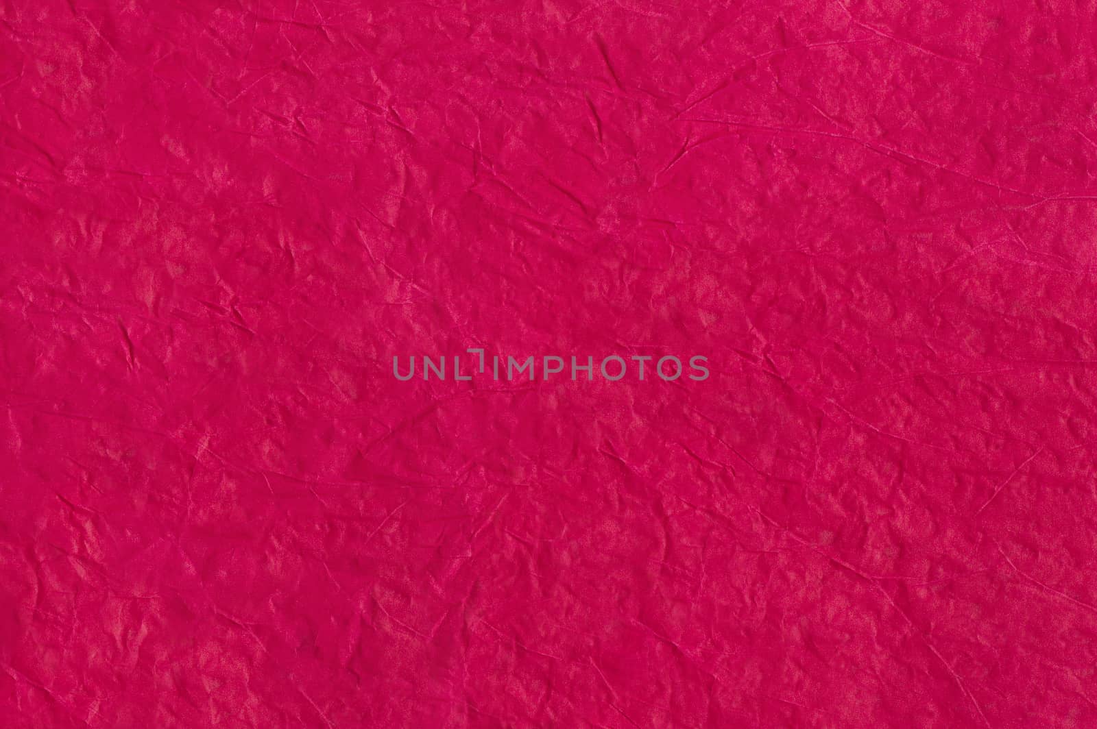 Bright crimson abstract background from crumpled paper. Crumpled paper texture. Paper wrinkles