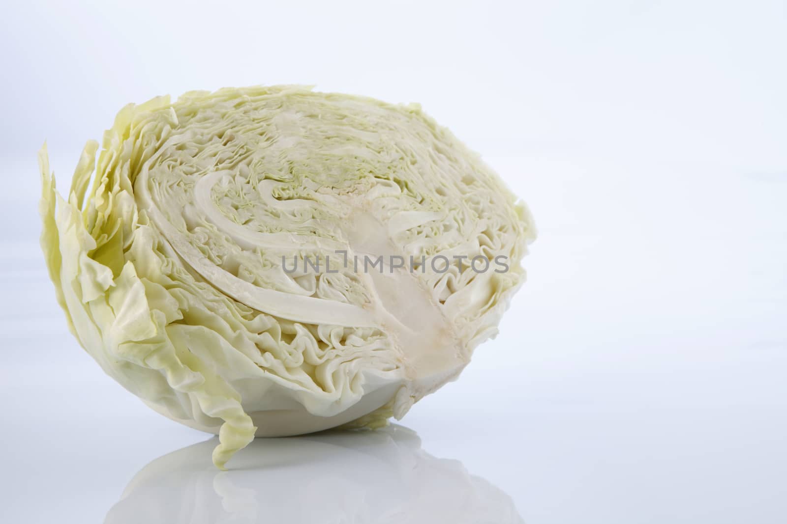 Cabbage cut in half isolated on white background