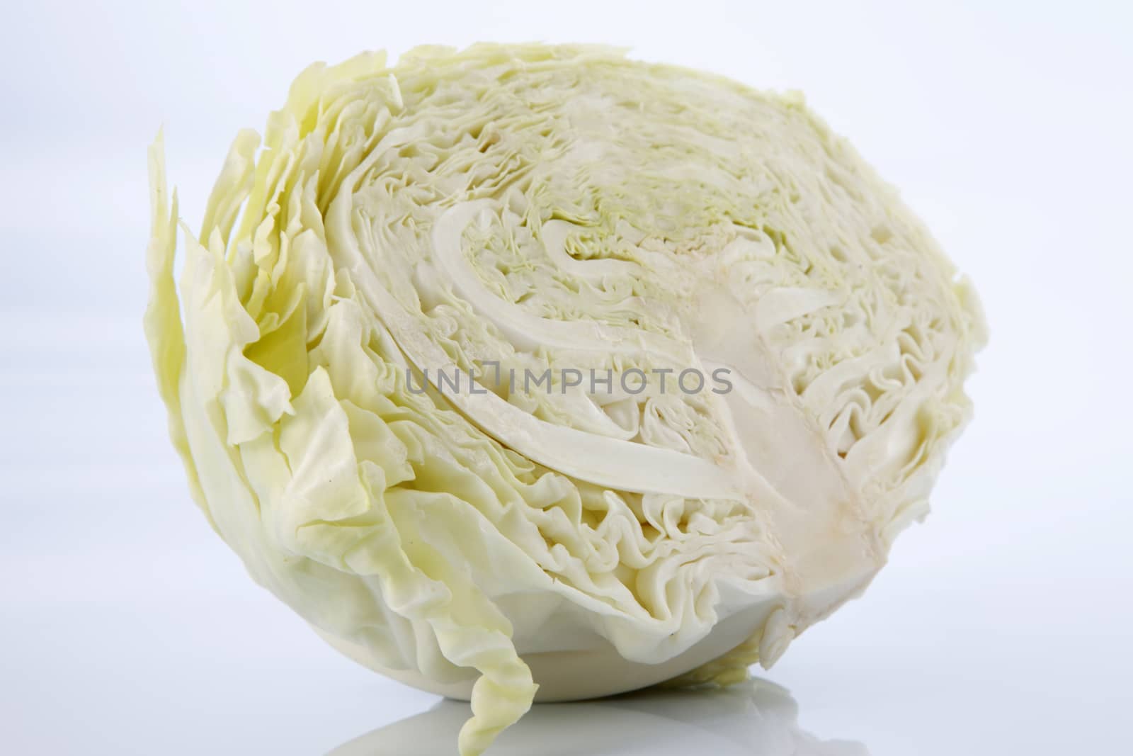 Cabbage cut in half isolated on white background