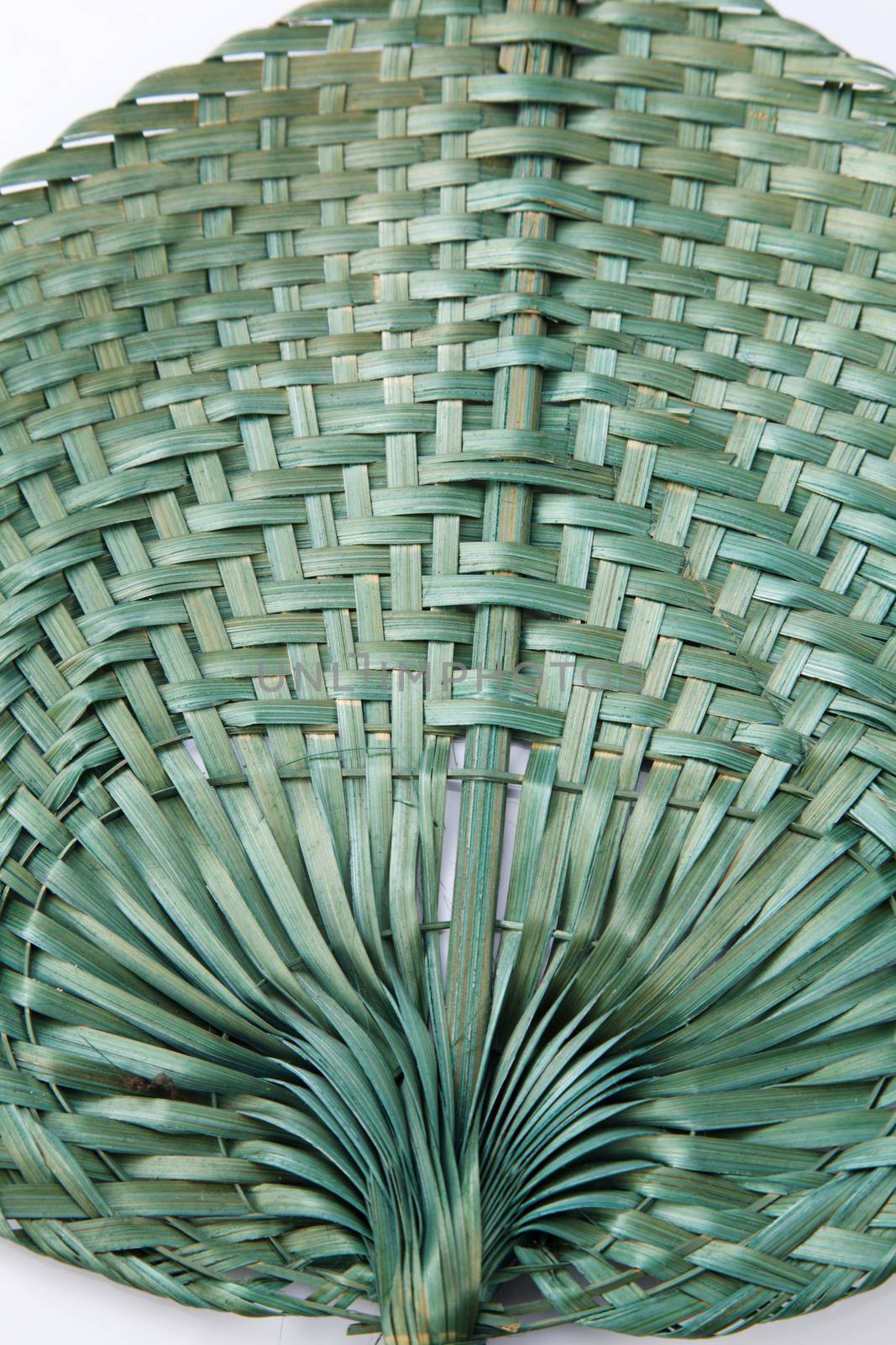 Green color native fan made from palm leaves on white background