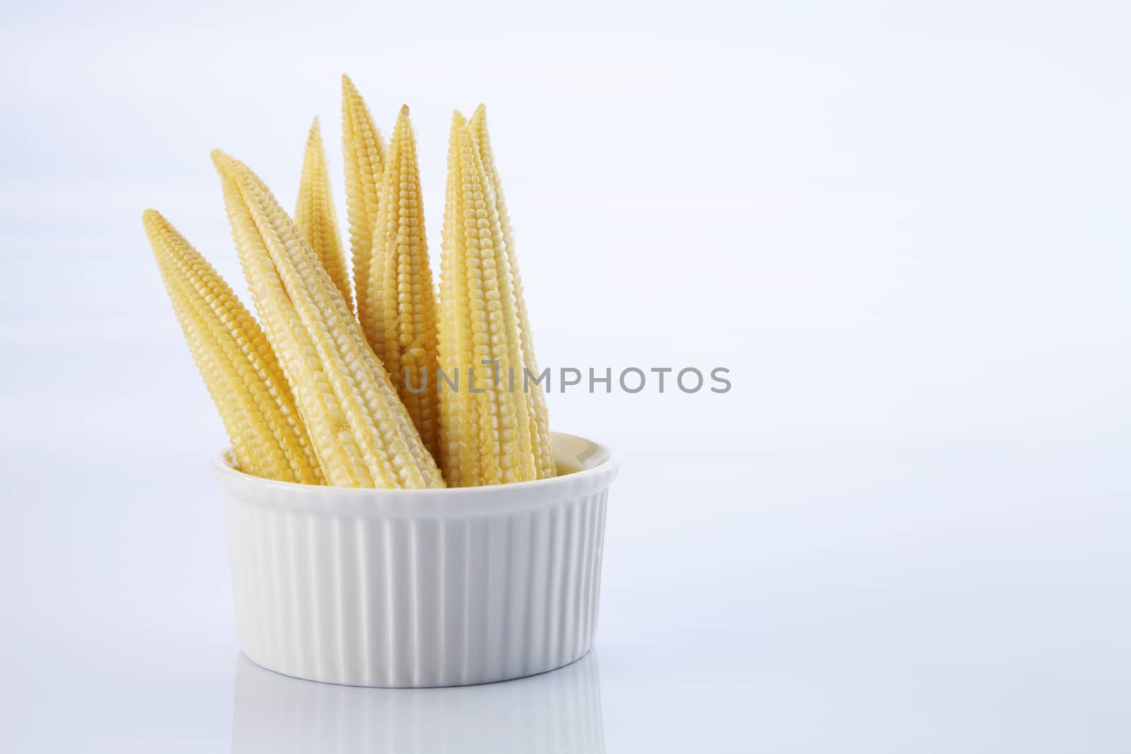 Baby corn on a white background, close-up