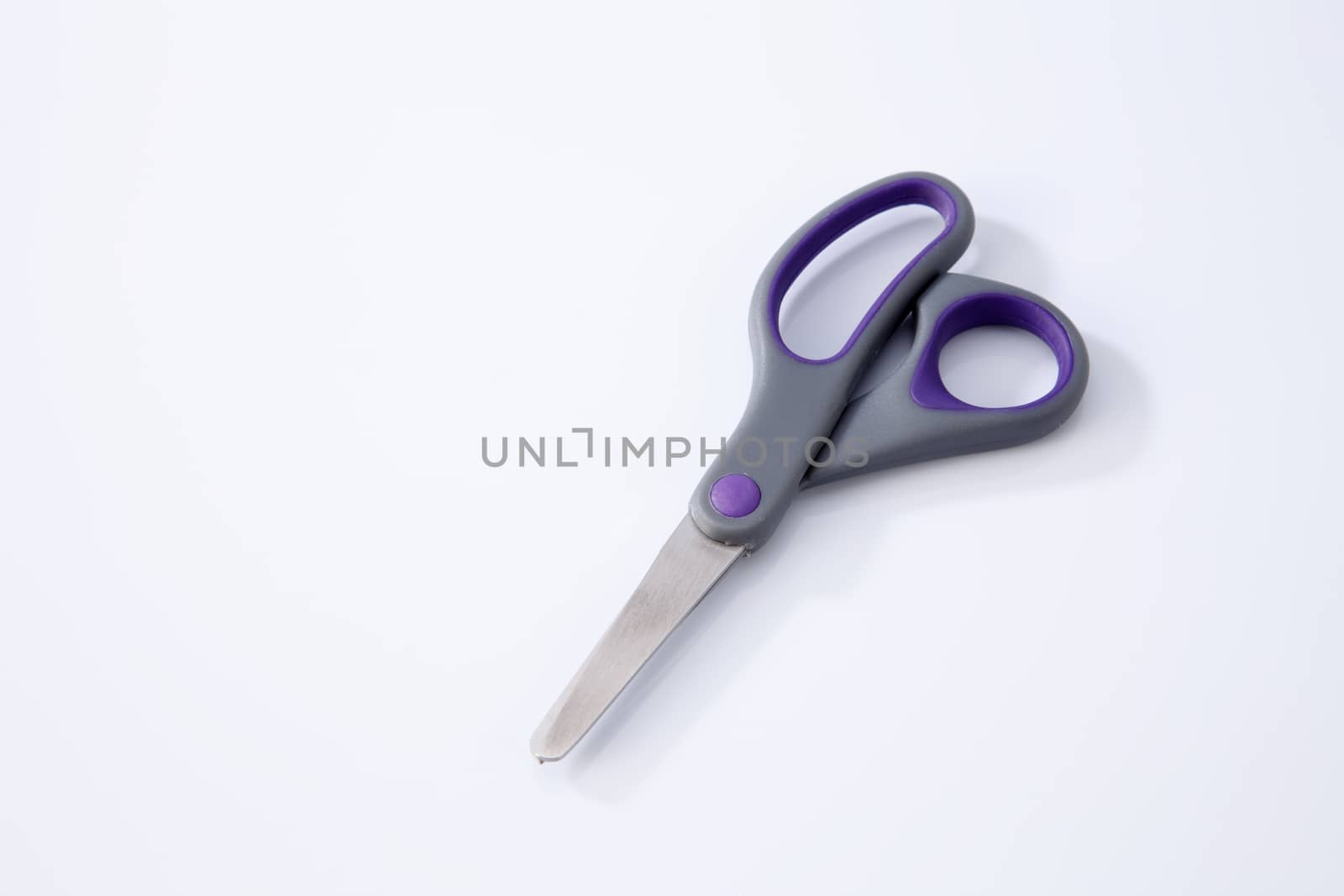 pair of scissors on the white background